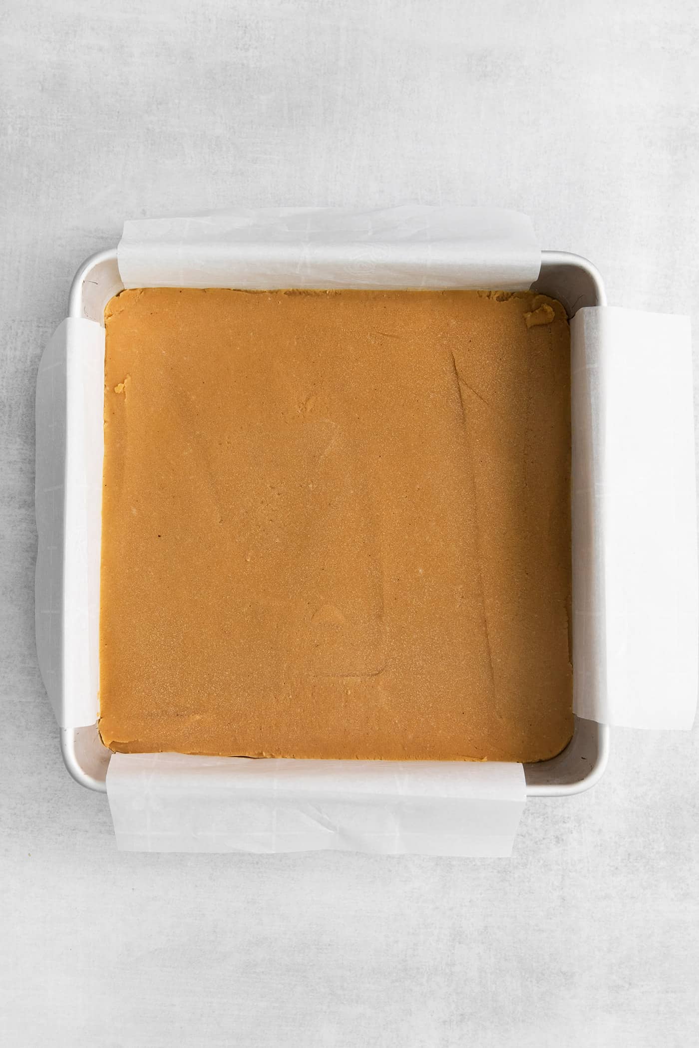 Made with 7 ingredients, this Homemade Peanut Butter Fudge is rich, creamy, and easy to make. It's the perfect fudge for the holidays! Peanut butter fudge in an 8x8 pan