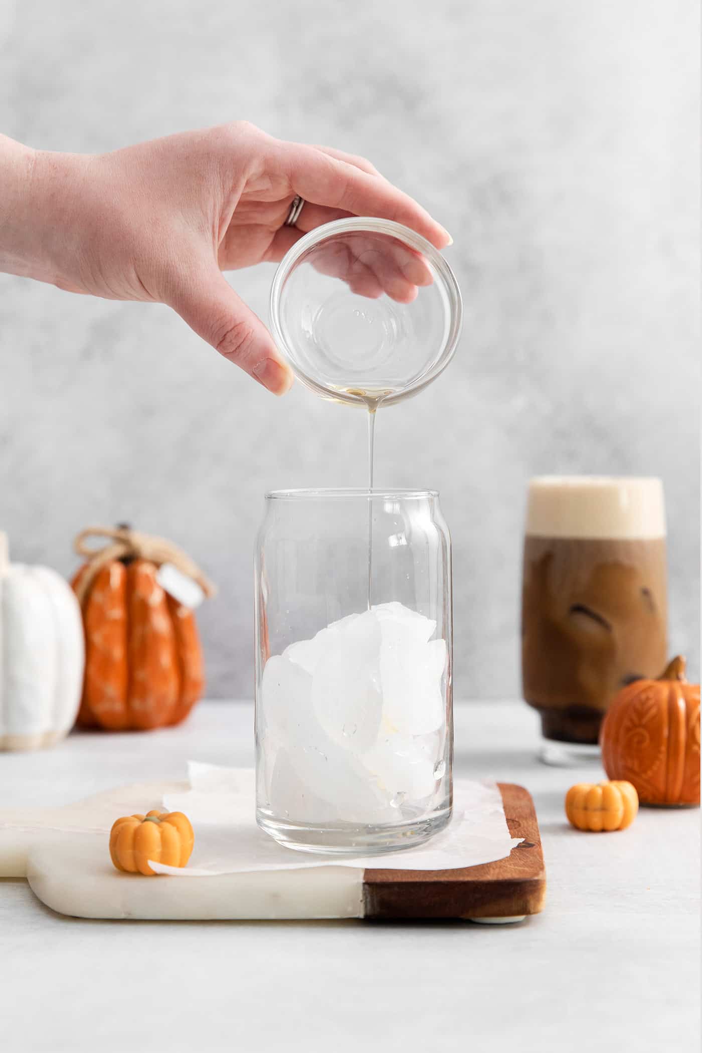 Lightly sweetened cold brew topped with a rich foam., this Pumpkin Cream Cold Foam is a Starbucks copycat you must try. A hand pouring liquid sugar into a glass