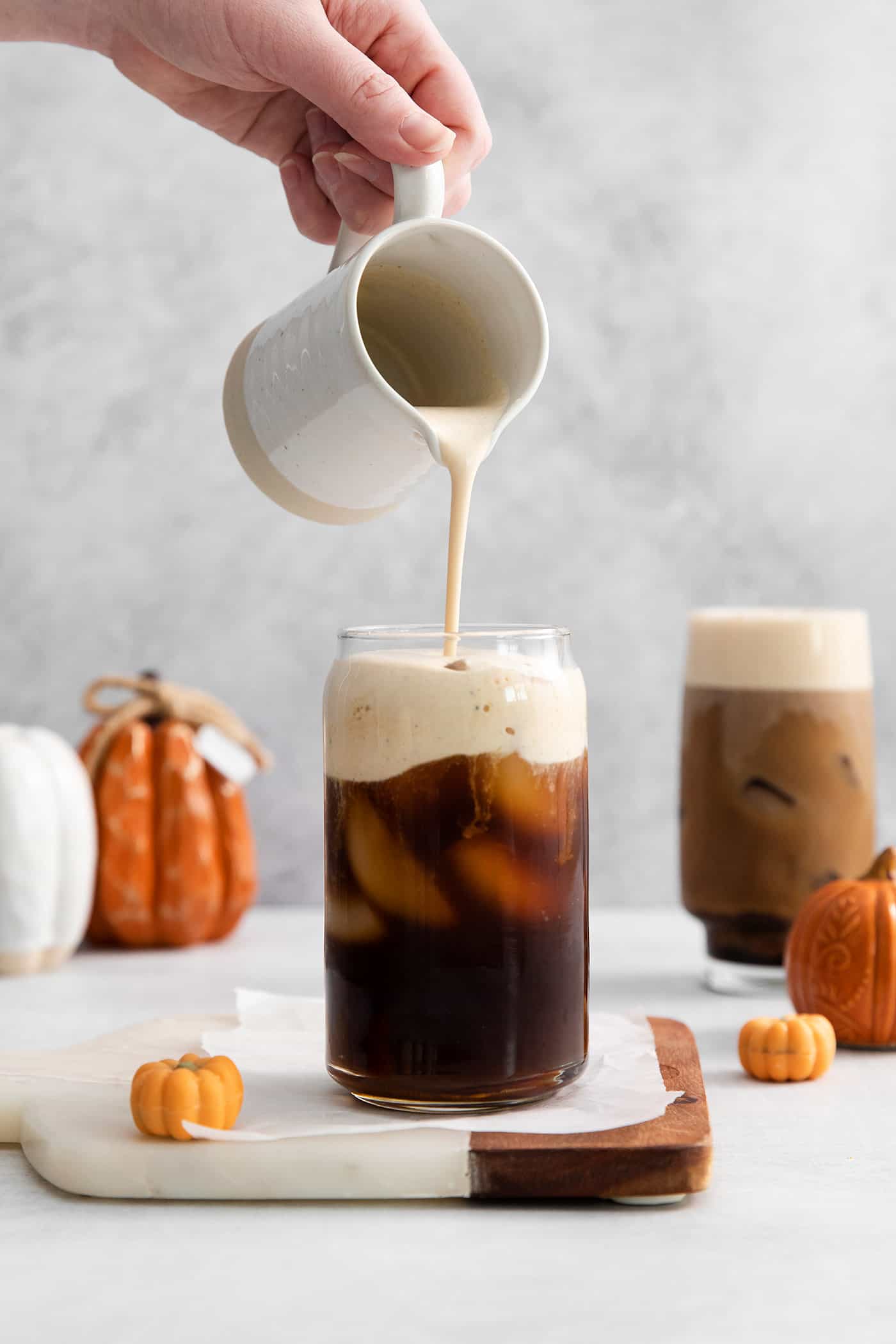 Lightly sweetened cold brew topped with a rich foam., this Pumpkin Cream Cold Foam is a Starbucks copycat you must try. A hand pouring cold foam over cold brew