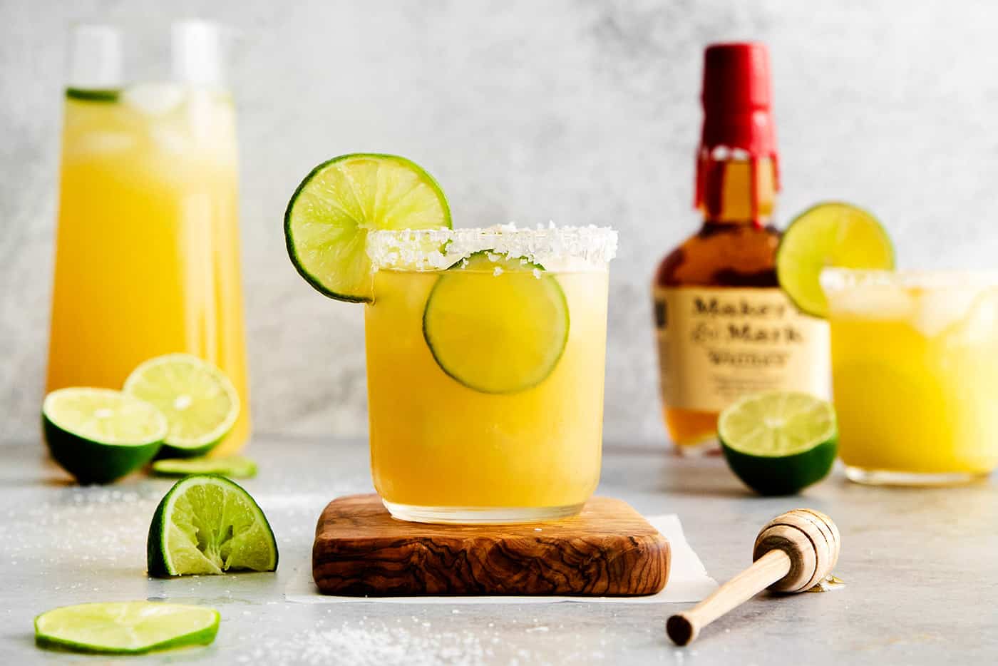 A bourbon margarita on a wooden coaster