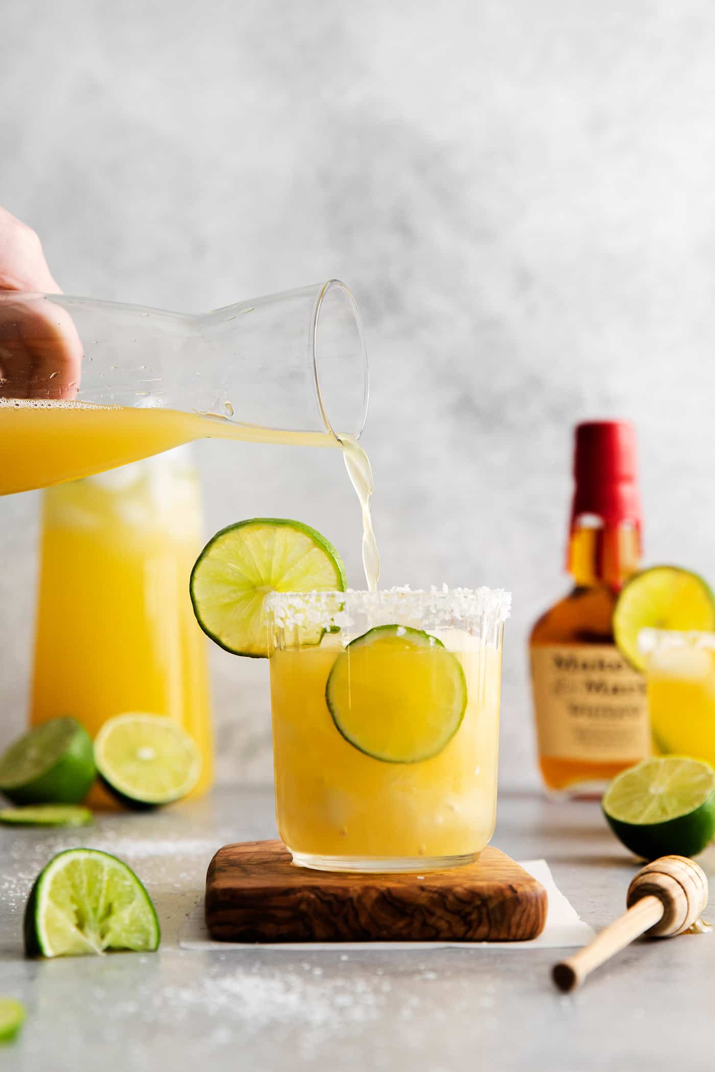 This Bourbon Margarita is a riff on a classic margarita, where bourbon replaces tequila. If you enjoy a whiskey sours, you’ll love this! Bourbon margarita being poured into a glass