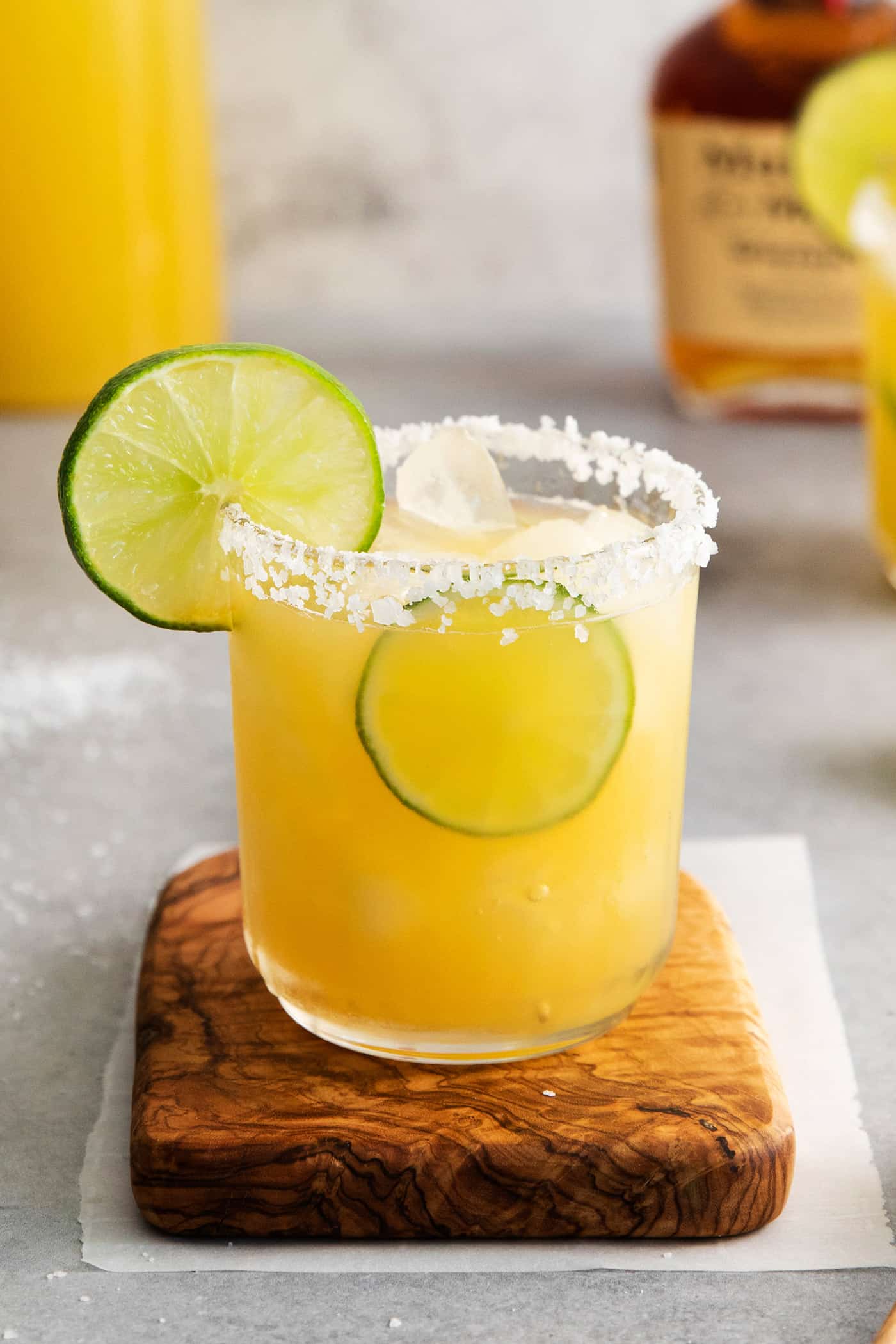 This Bourbon Margarita is a riff on a classic margarita, where bourbon replaces tequila. If you enjoy a whiskey sours, you’ll love this! Angled view of a whiskey margarita
