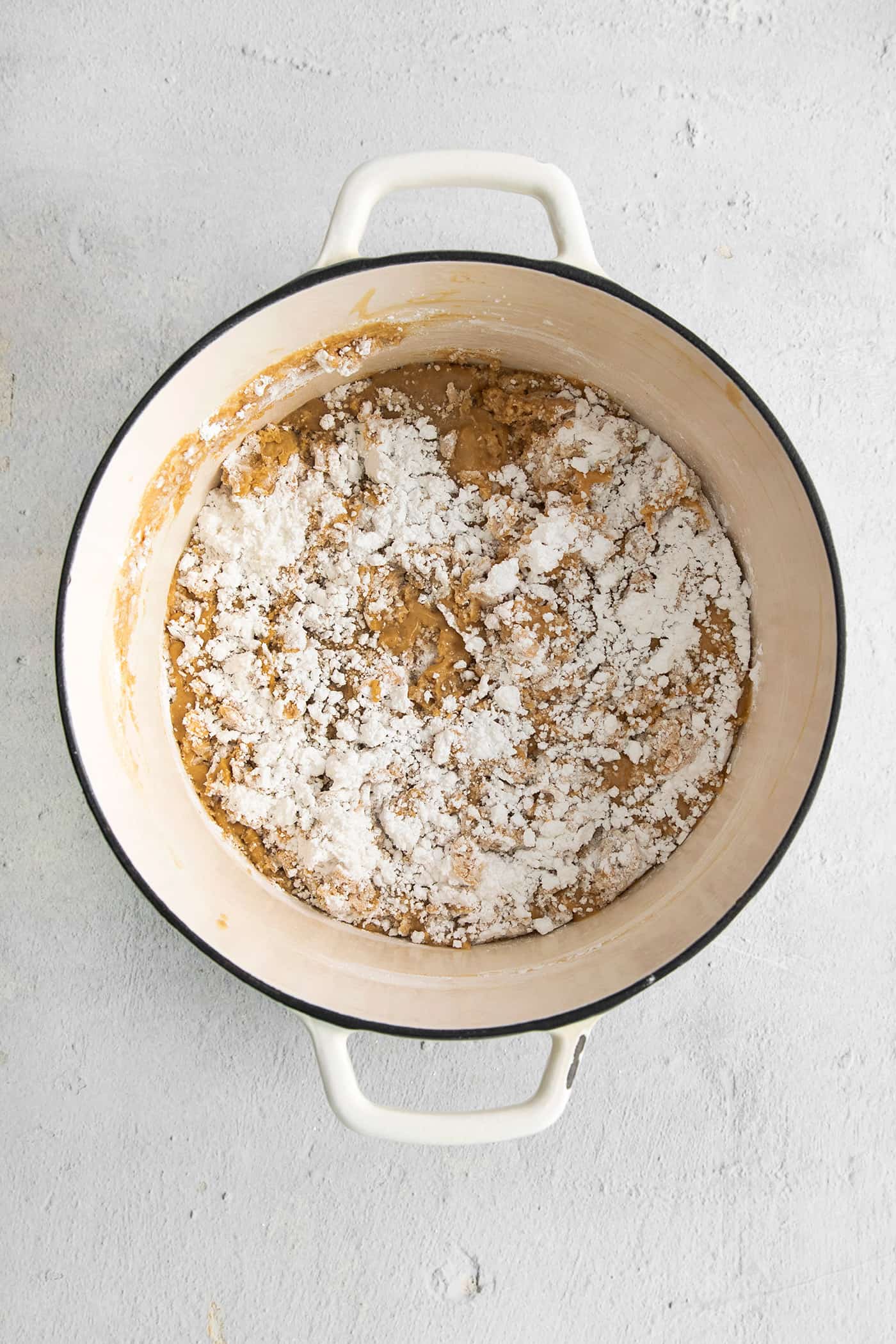 This Buckeye Fudge is a fun twist on traditional buckeyes, with smooth, creamy peanut butter fudge topped with a layer of rich chocolate. Powdered sugar stirred into a peanut butter mixture