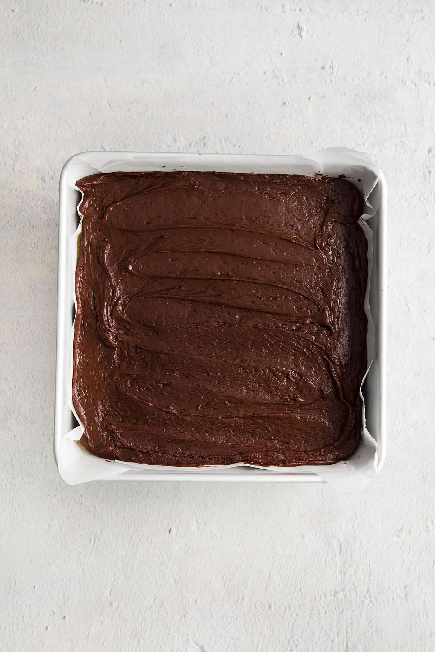 This Buckeye Fudge is a fun twist on traditional buckeyes, with smooth, creamy peanut butter fudge topped with a layer of rich chocolate. Chocolate fudge in an 8x8 pan