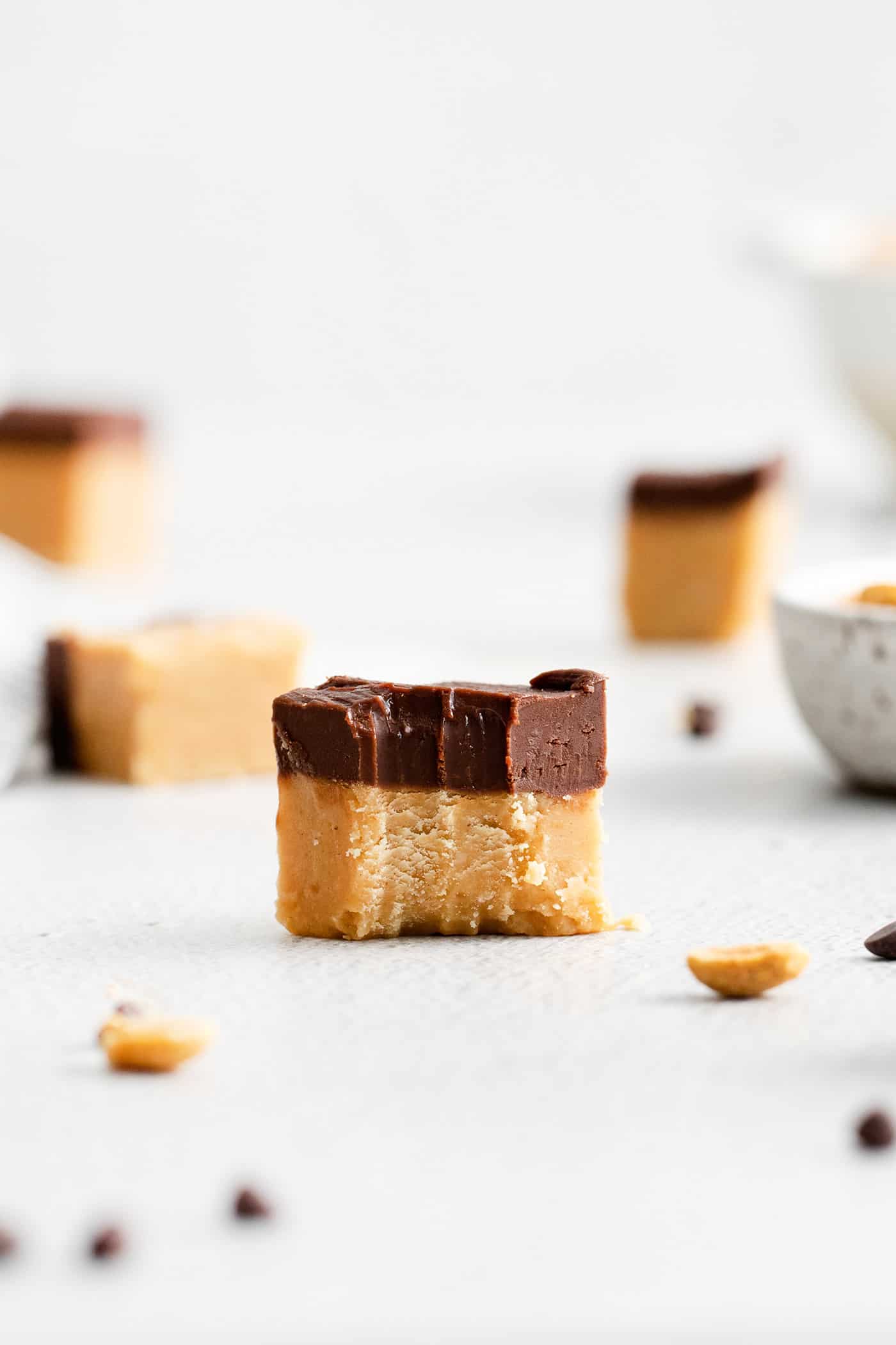 This Buckeye Fudge is a fun twist on traditional buckeyes, with smooth, creamy peanut butter fudge topped with a layer of rich chocolate. A piece of buckeye fudge with a bite missing
