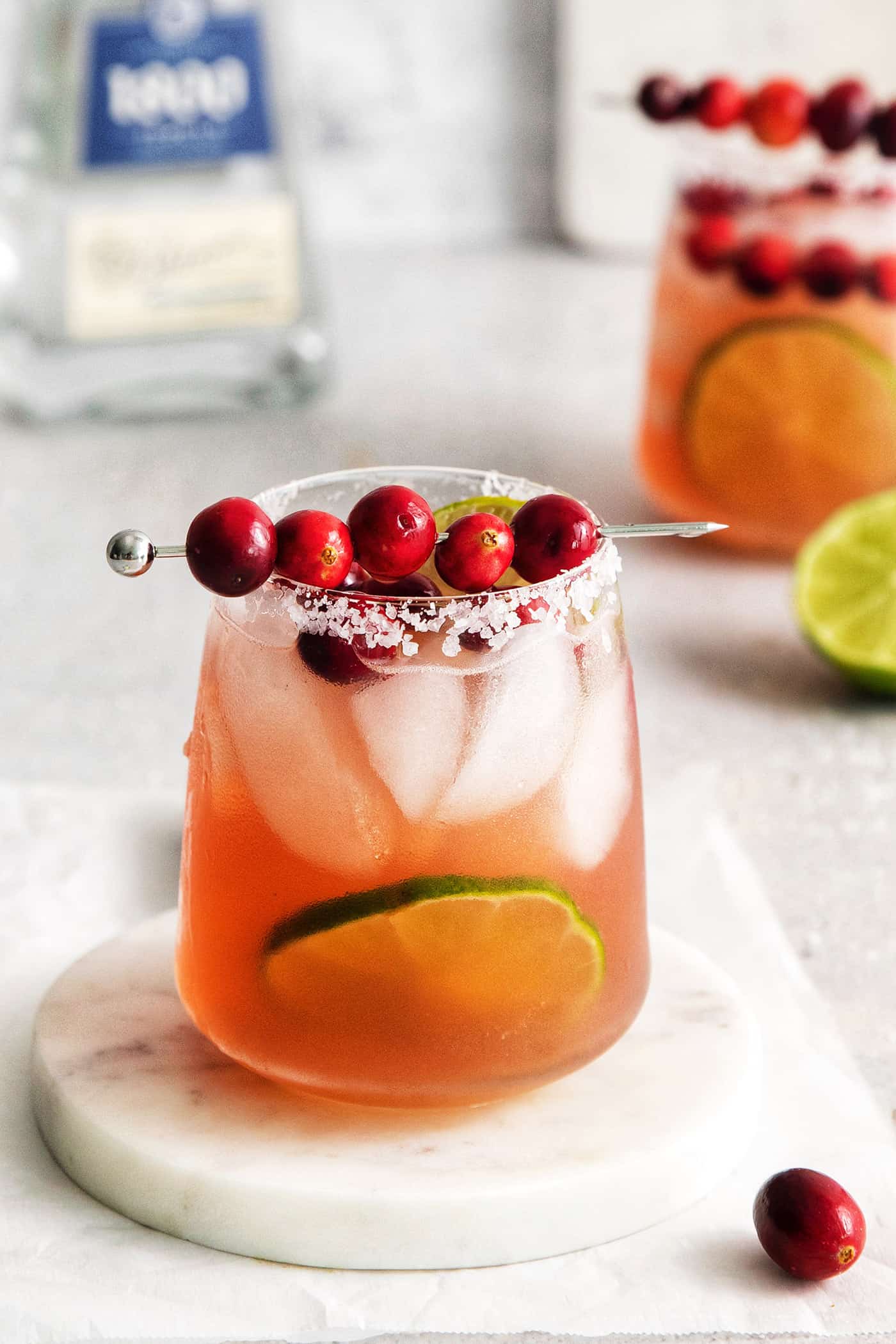 This Cranberry Margarita is tart and refreshing with flavors of cranberry and lime. A great Christmas margarita option! Angled view of a Christmas margarita