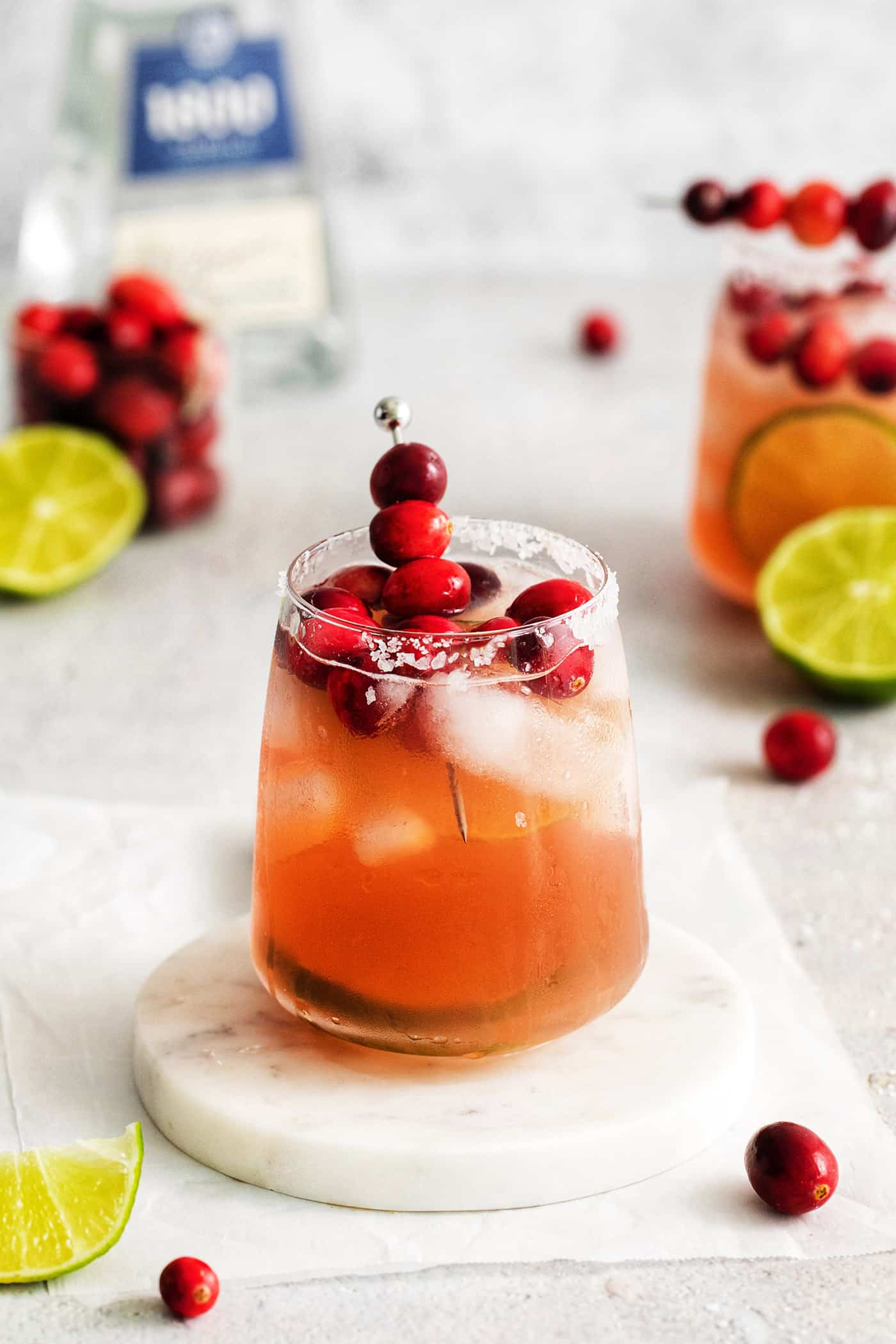 This Cranberry Margarita is tart and refreshing with flavors of cranberry and lime. A great Christmas margarita option! A Christmas margarita on a white coaster