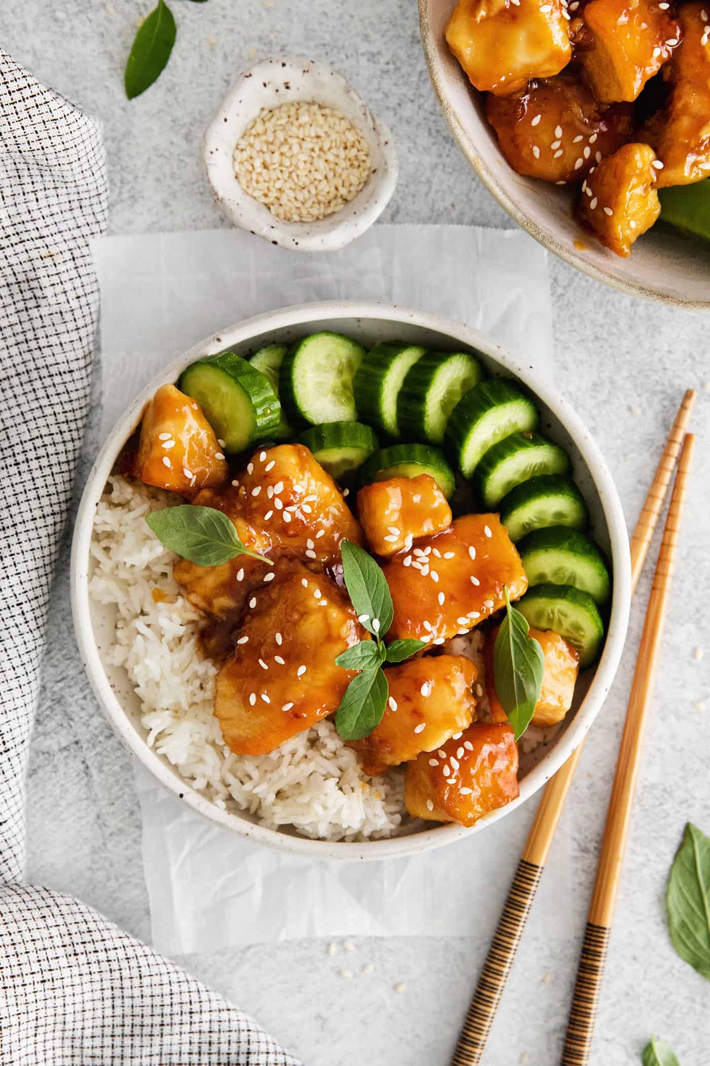 These Honey Garlic Chicken Bowls are quick and easy with moist chunks of chicken tossed in a sweet and sticky garlic sauce. Overhead view of a honey garlic chicken rice bowl
