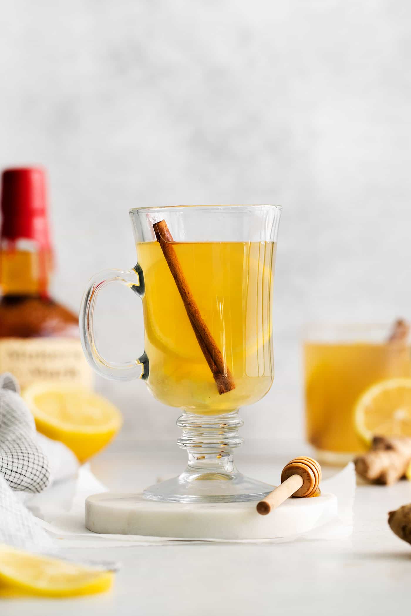 This Hot Toddy is the perfect winter drink! It’s warm and cozy with a hint of earthy honey, spicy ginger, and a burst of lemon. A hot toddy in a glass mug