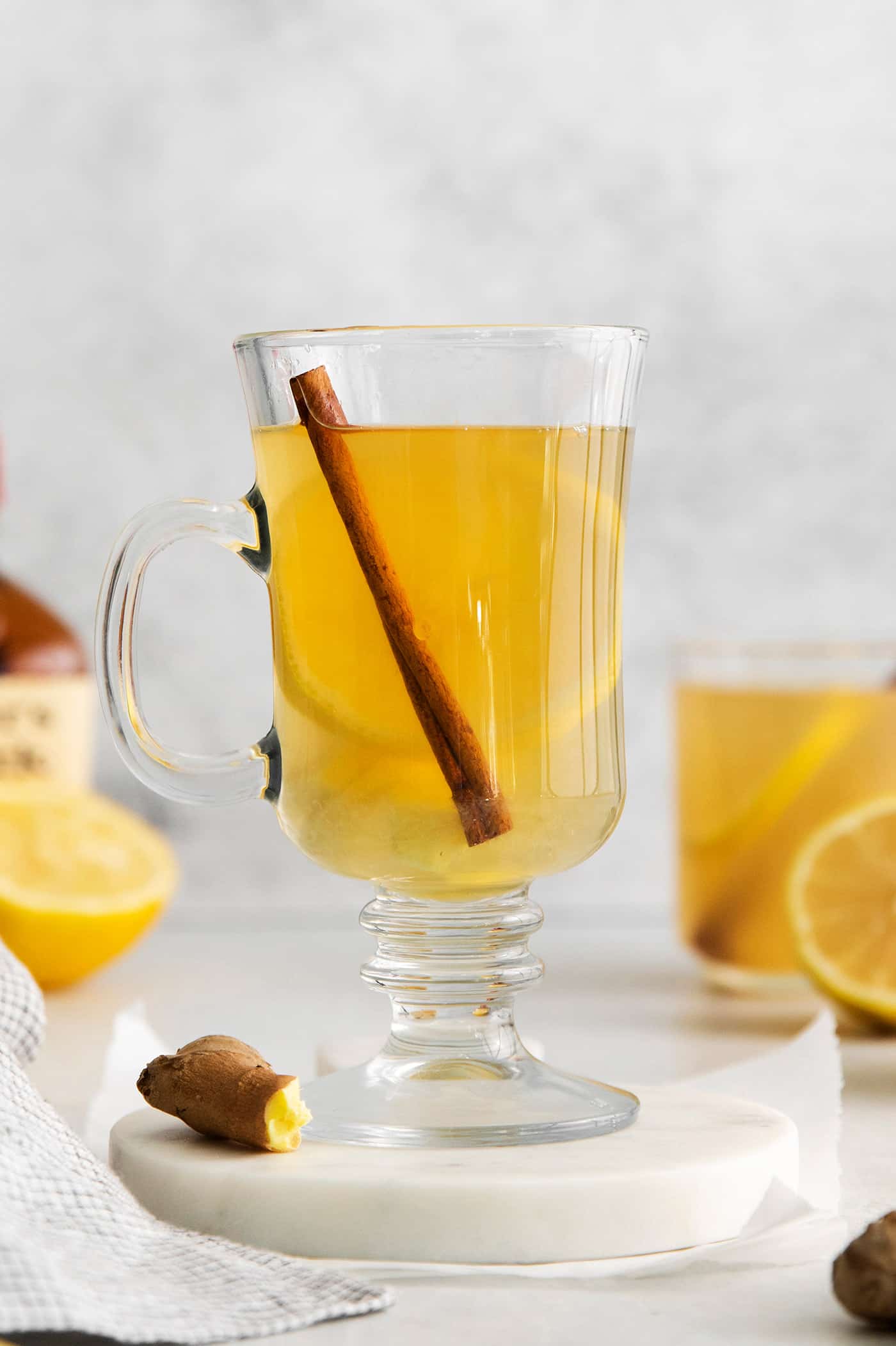 This Hot Toddy is the perfect winter drink! It’s warm and cozy with a hint of earthy honey, spicy ginger, and a burst of lemon. Hot toddy in a glass mug