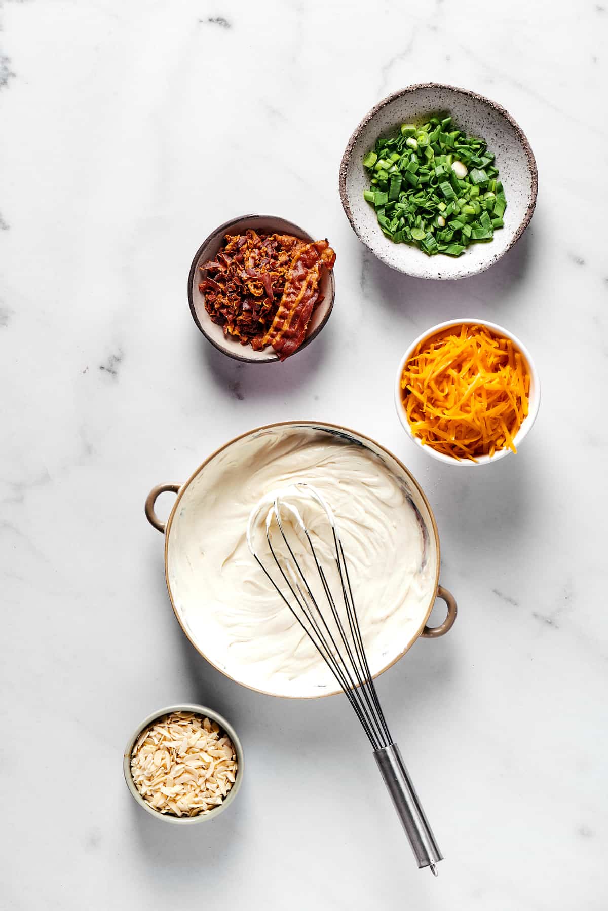 Million Dollar Dip is creamy, cheesy, and super easy to make. With cheese, bacon, and almonds, it's a super addicting party dip. Cream cheese and mayonnaise mixed in a bowl