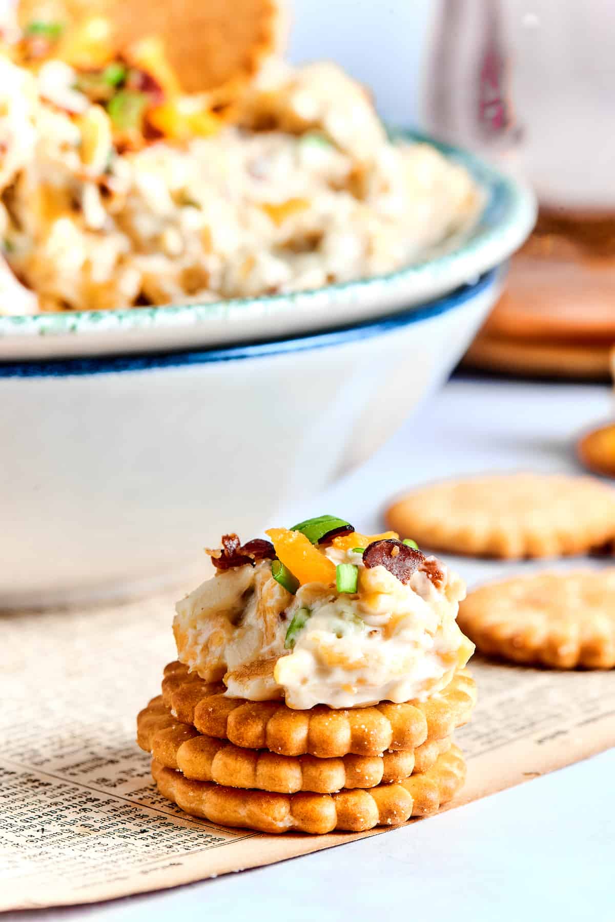 Million Dollar Dip is creamy, cheesy, and super easy to make. With cheese, bacon, and almonds, it's a super addicting party dip. A stack of Ritz crackers topped with million dollar dip