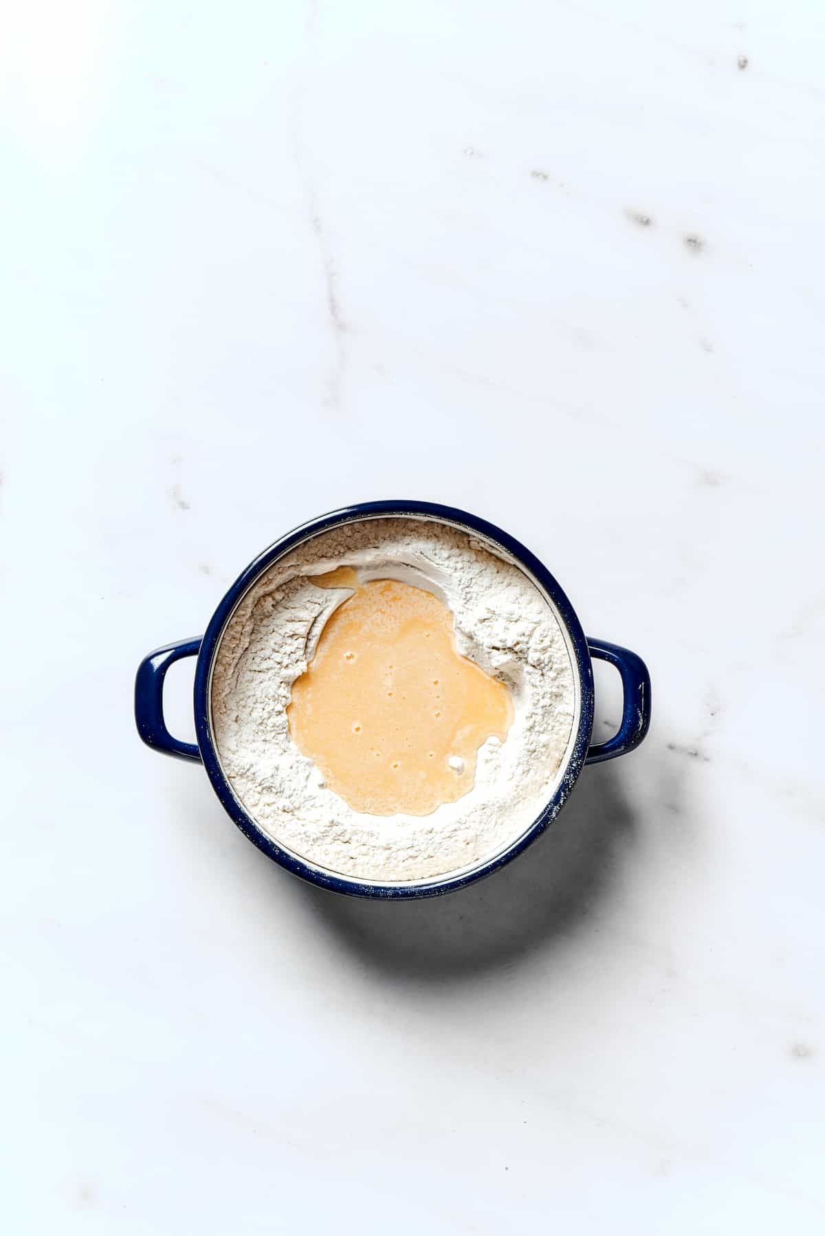 Potato Knishes are a popular Jewish recipe featuring a mashed potato and onion filling wrapped in a thin, flaky dough and baked to golden. A wet ingredient mixture added to the well of dry ingredients