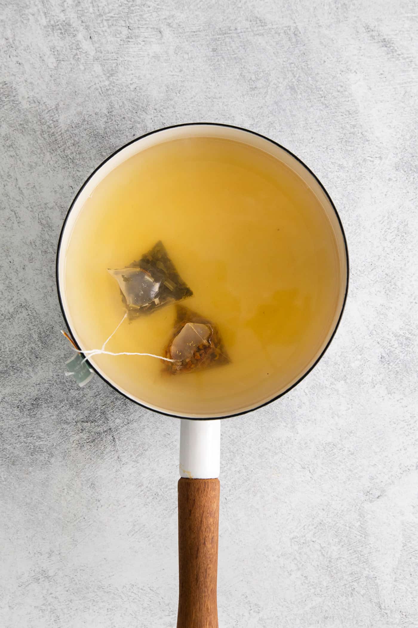 Made with citrus mint and peach tea, lemon, and honey, Starbucks Medicine Ball Recipe is just the thing for those chilly months. Two tea bags steeping in a saucepan of water