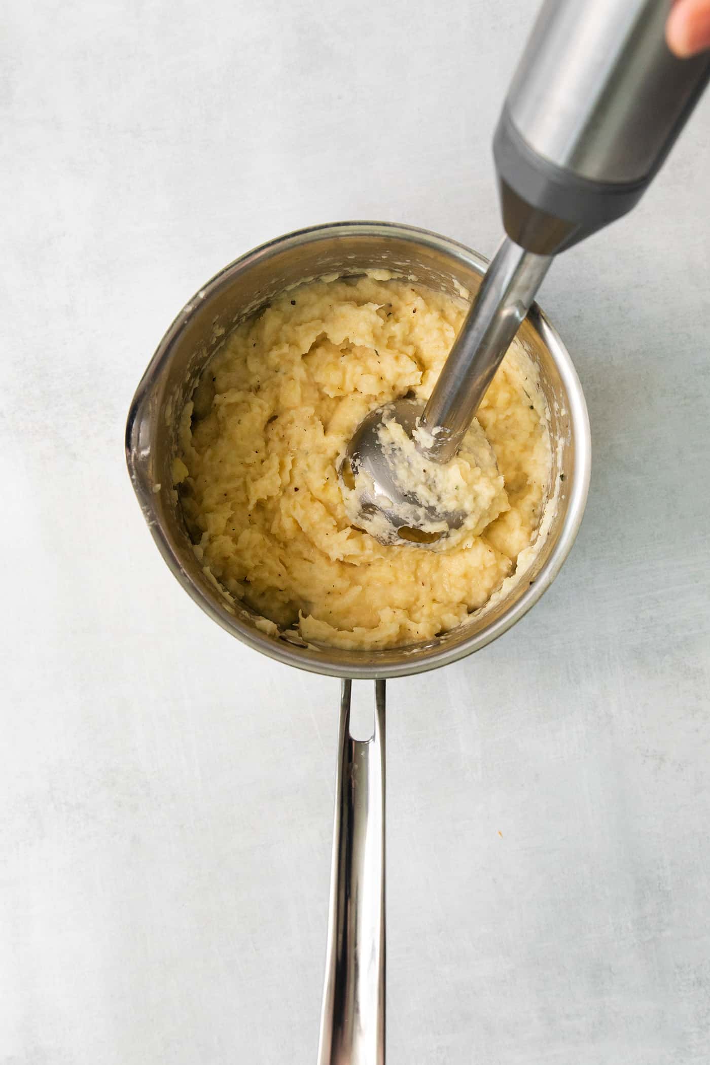 Parsnip Puree is a tasty side dish that is simple enough for every day but impressive enough for the holidays! An immersion blender mashing boiled parsnip