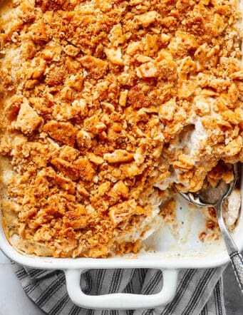 a white serving dish of chicken poppy seed casserole