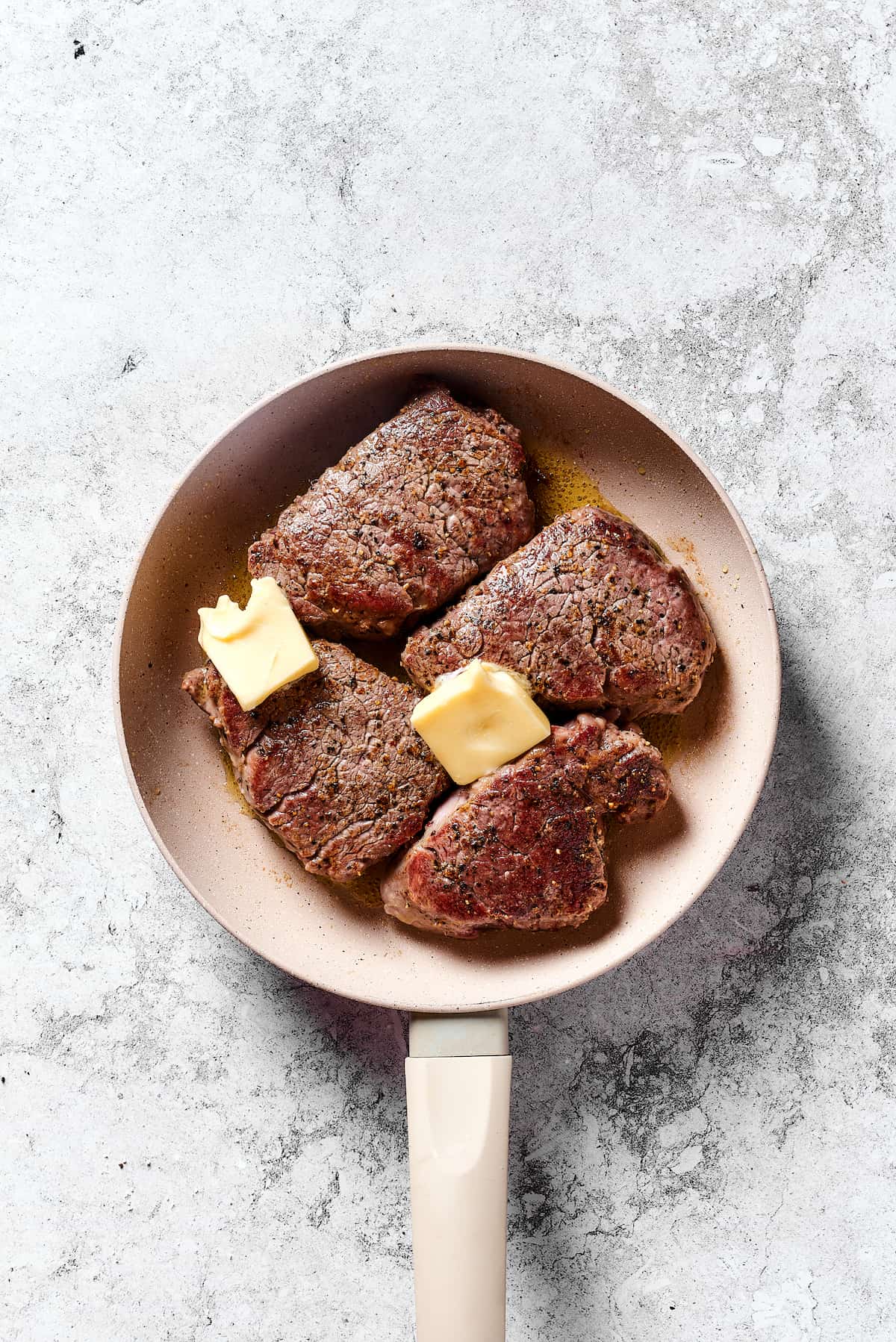 Steak Diane is a classic beef tenderloin recipe with pan-cooked steak in a creamy mushroom sauce. Simple but elegant & ready in 45 minutes. Seared beef tenderloin in a pan with butter