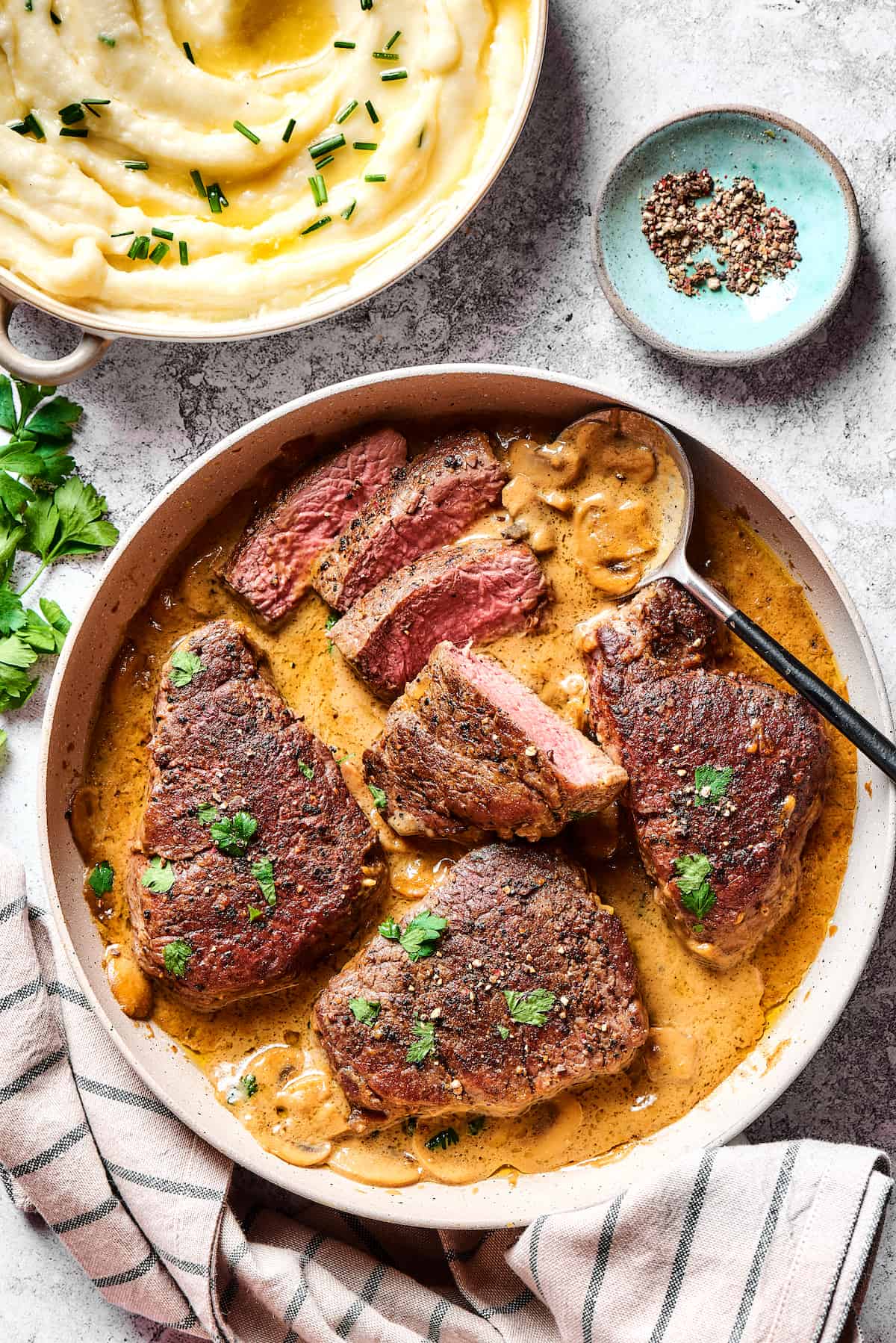Steak Diane is a classic beef tenderloin recipe with pan-cooked steak in a creamy mushroom sauce. Simple but elegant & ready in 45 minutes. Overhead view of steak with Diane sauce in a pan