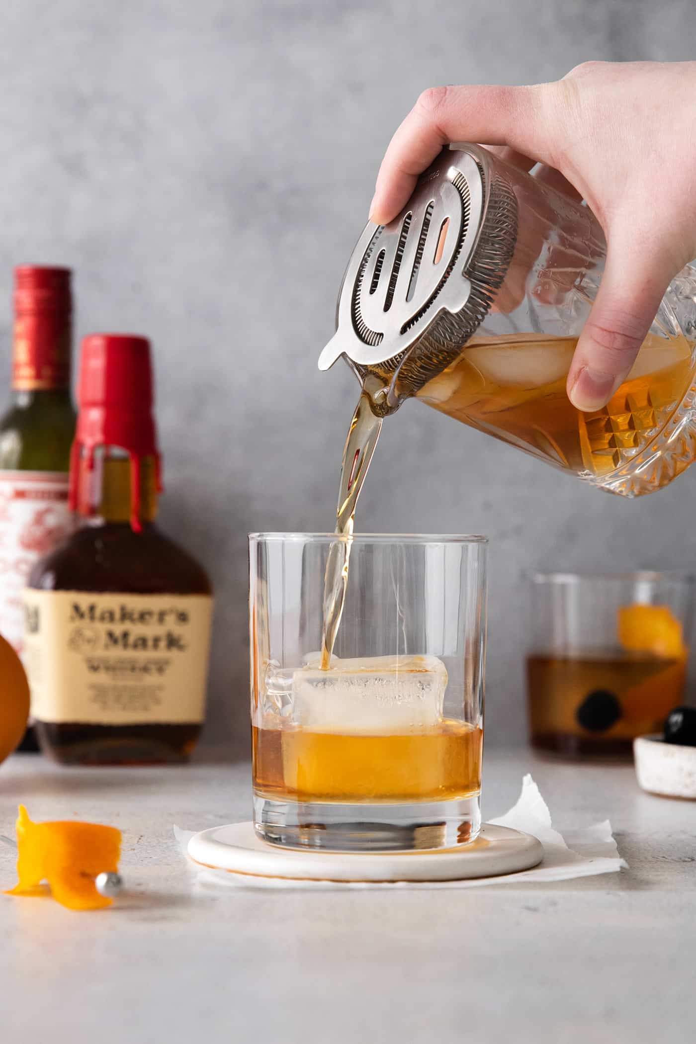 This classic Manhattan is a strong and earthy cocktail with just a hint of sweetness. Fancy and elegant, with 3 ingredients. Manhattan drink being pouring over ice