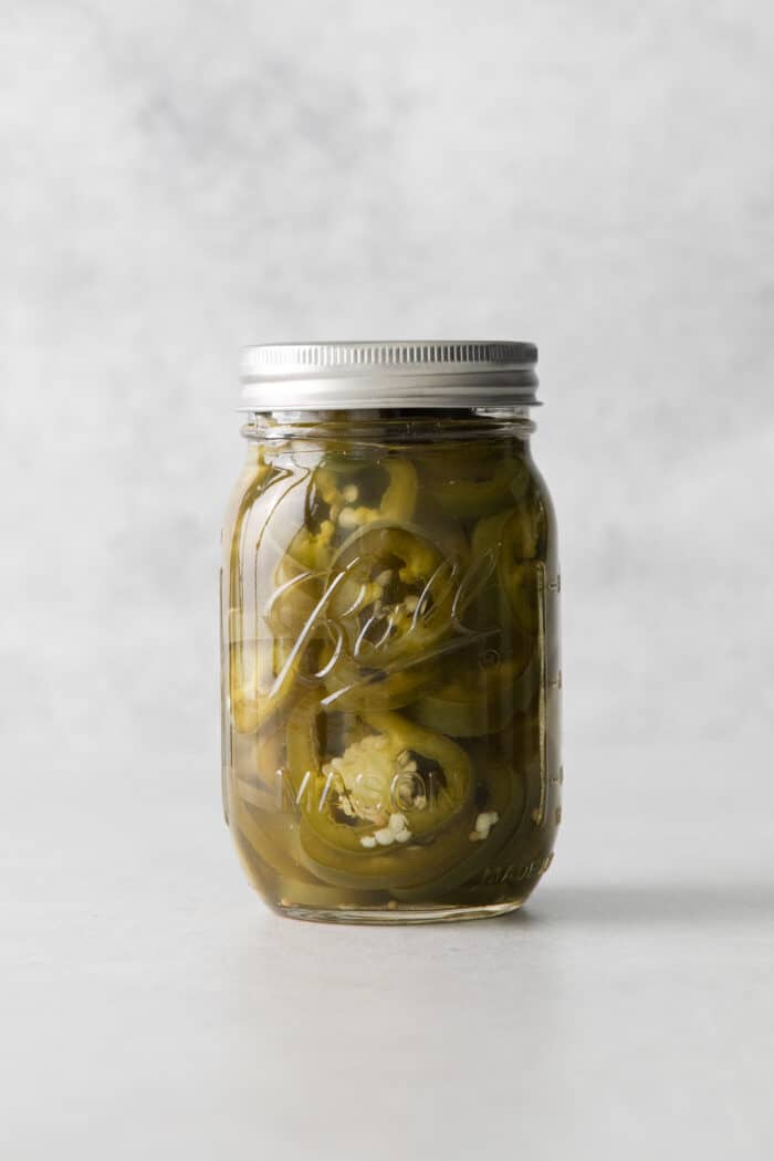 With just 5 ingredients, these Pickled Jalapenos are spicy and tangy. Add them to sandwiches and salads or straight from the jar. A jar of pickled jalapenos