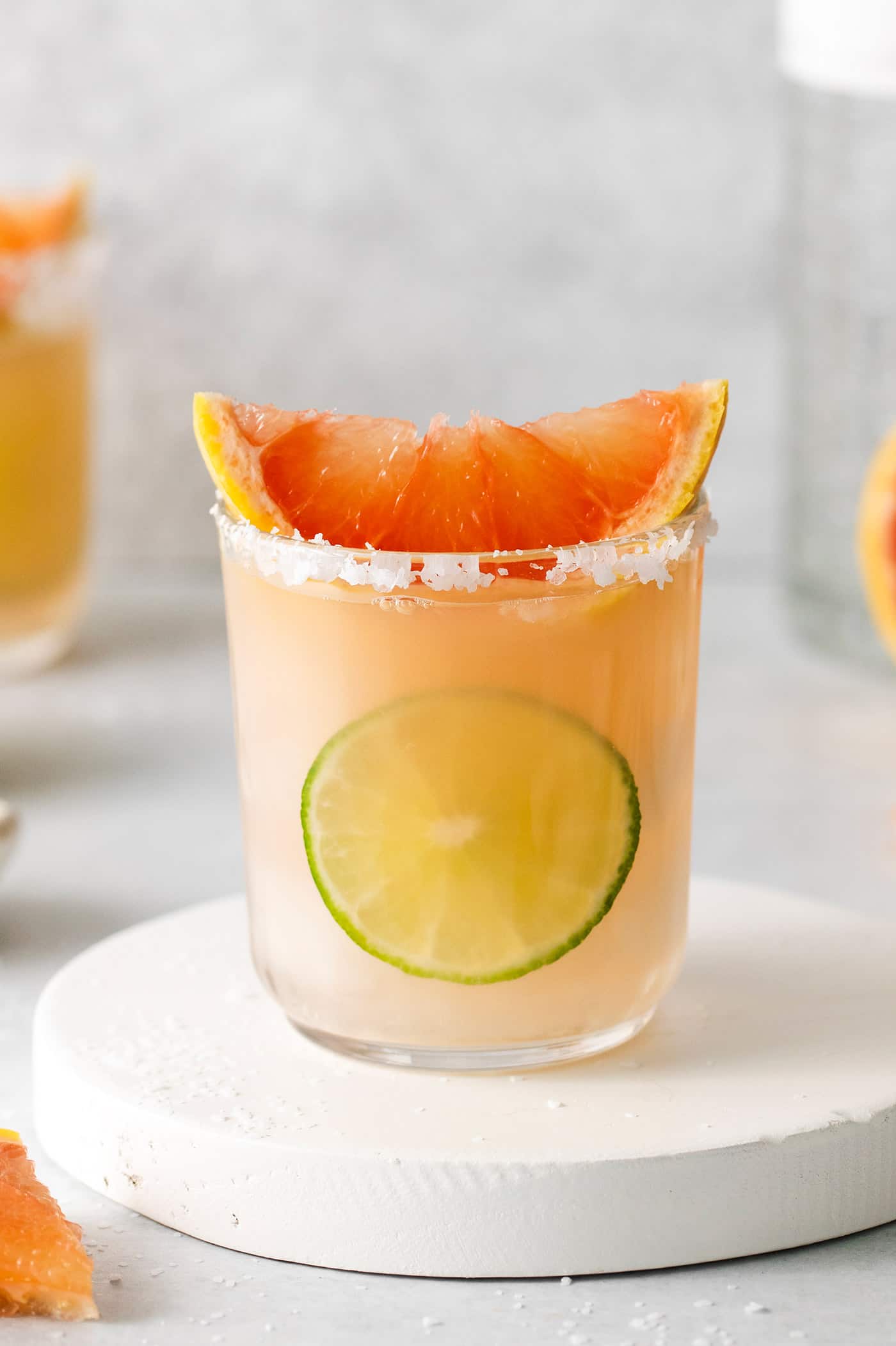 This Salty Dog cocktail is a twist on a classic greyhound that features gin and a coarse salt rim. The cocktail is fruity and refreshing. A salty dog cocktail topped with a slice of grapefruit