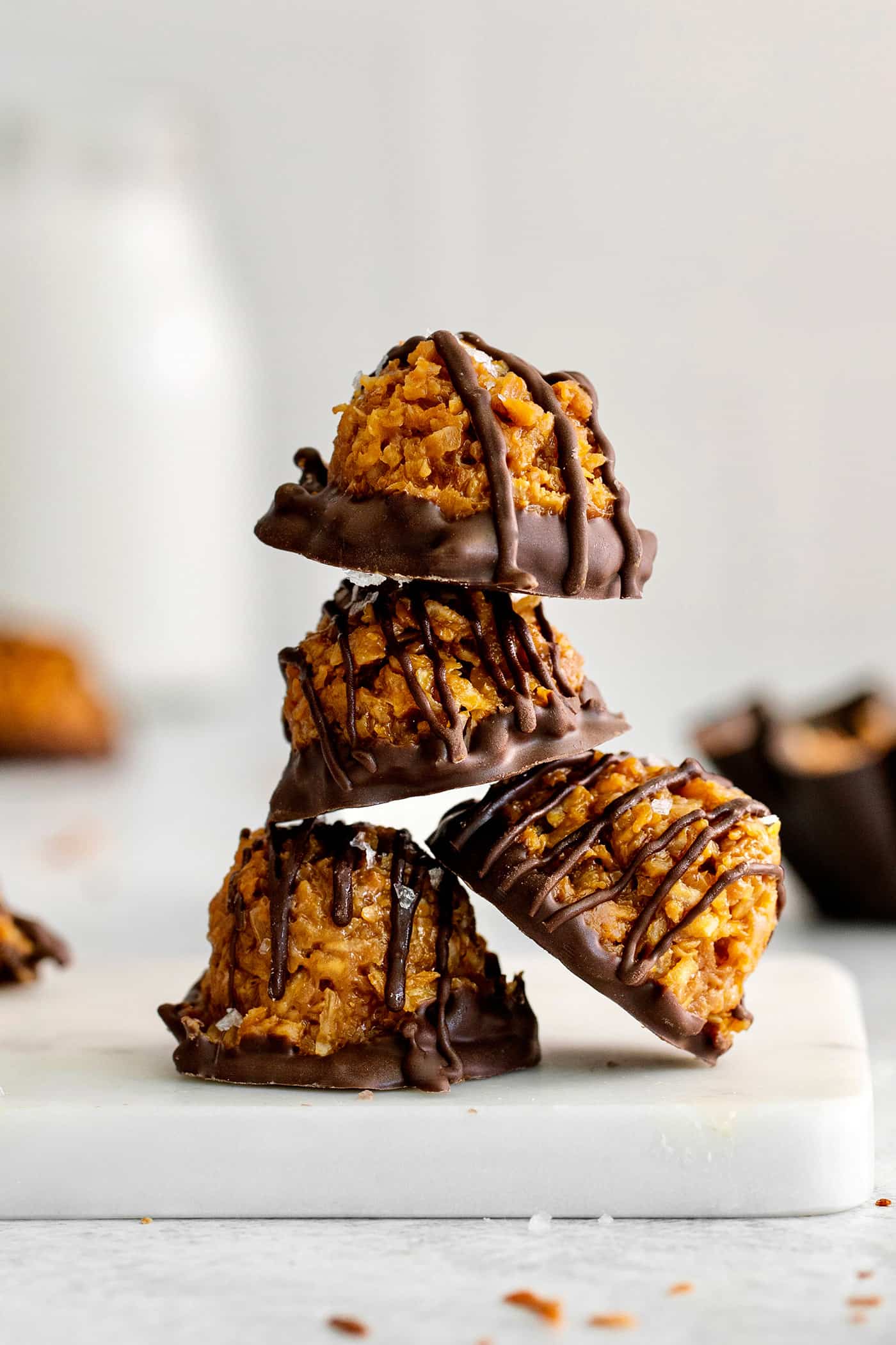 These Samoa Macaroons are rich and nutty, made with toasted coconut and dulce de leche and then dipped in chocolate. A stack of dulce de leche macaroons