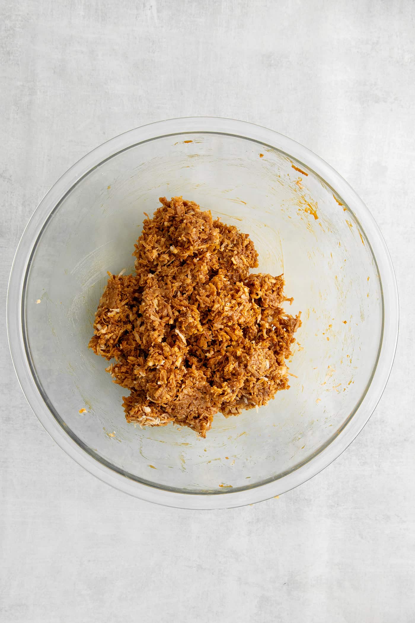 These Samoa Macaroons are rich and nutty, made with toasted coconut and dulce de leche and then dipped in chocolate. Toasted coconut mixed with dulce de leche in a bowl