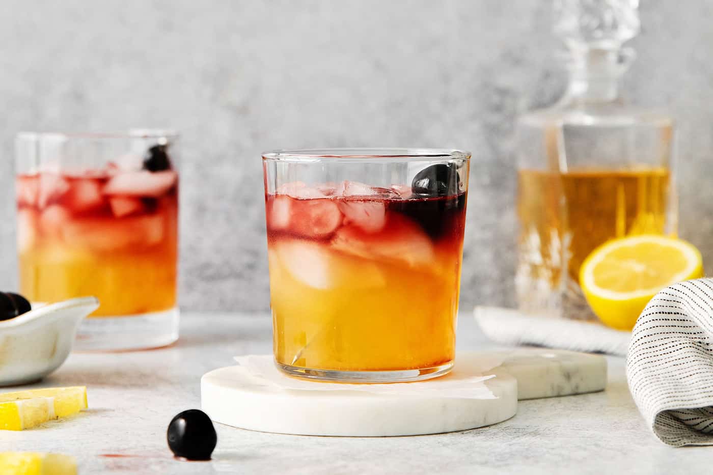 A New York Sour cocktail on a marble coaster