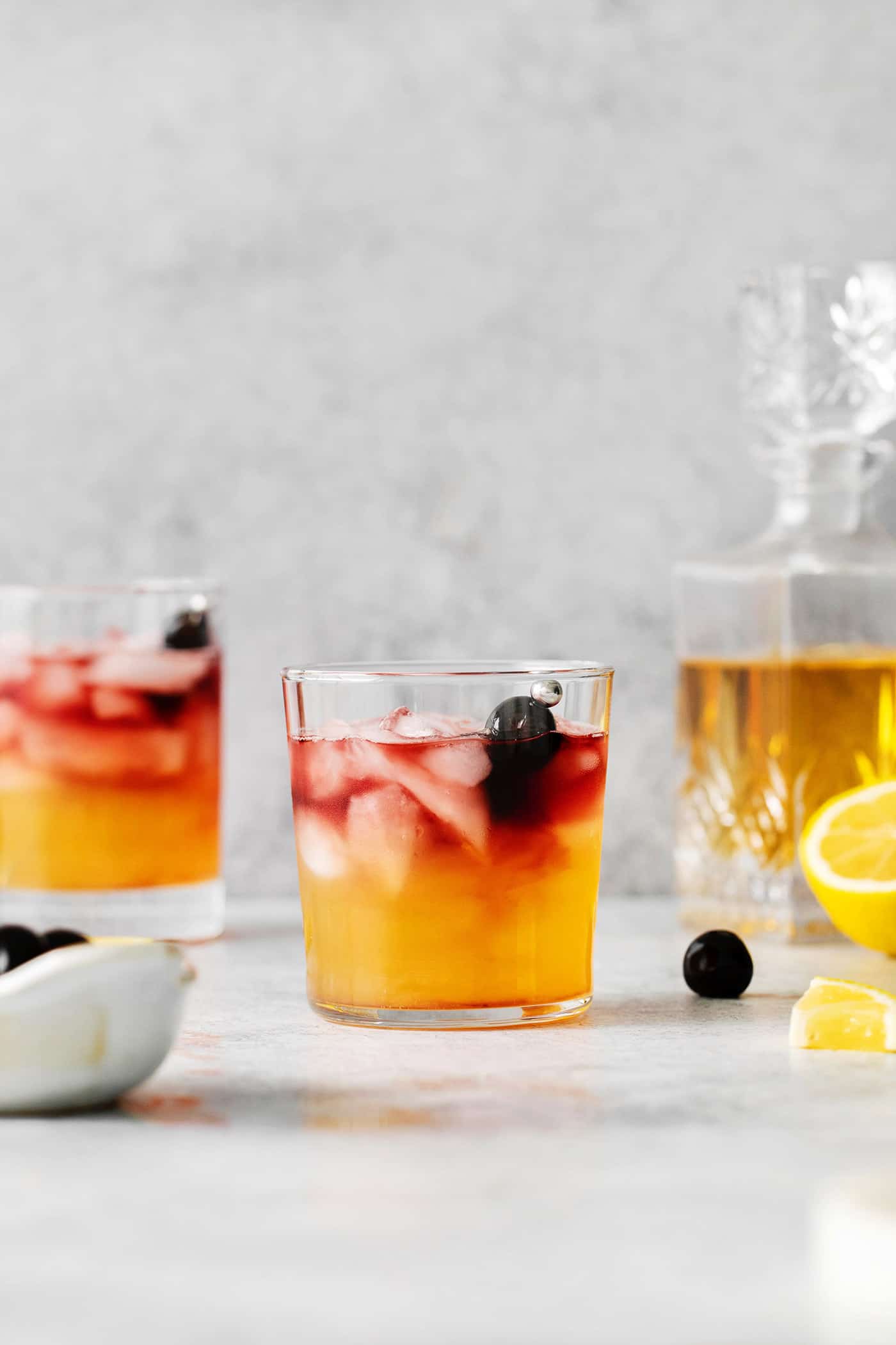 This New York Sour is made with whiskey, freshly squeezed lemon juice, simple syrup, and fruity red wine. Perfectly sweet & tart. A New York Sour on a marble countertop