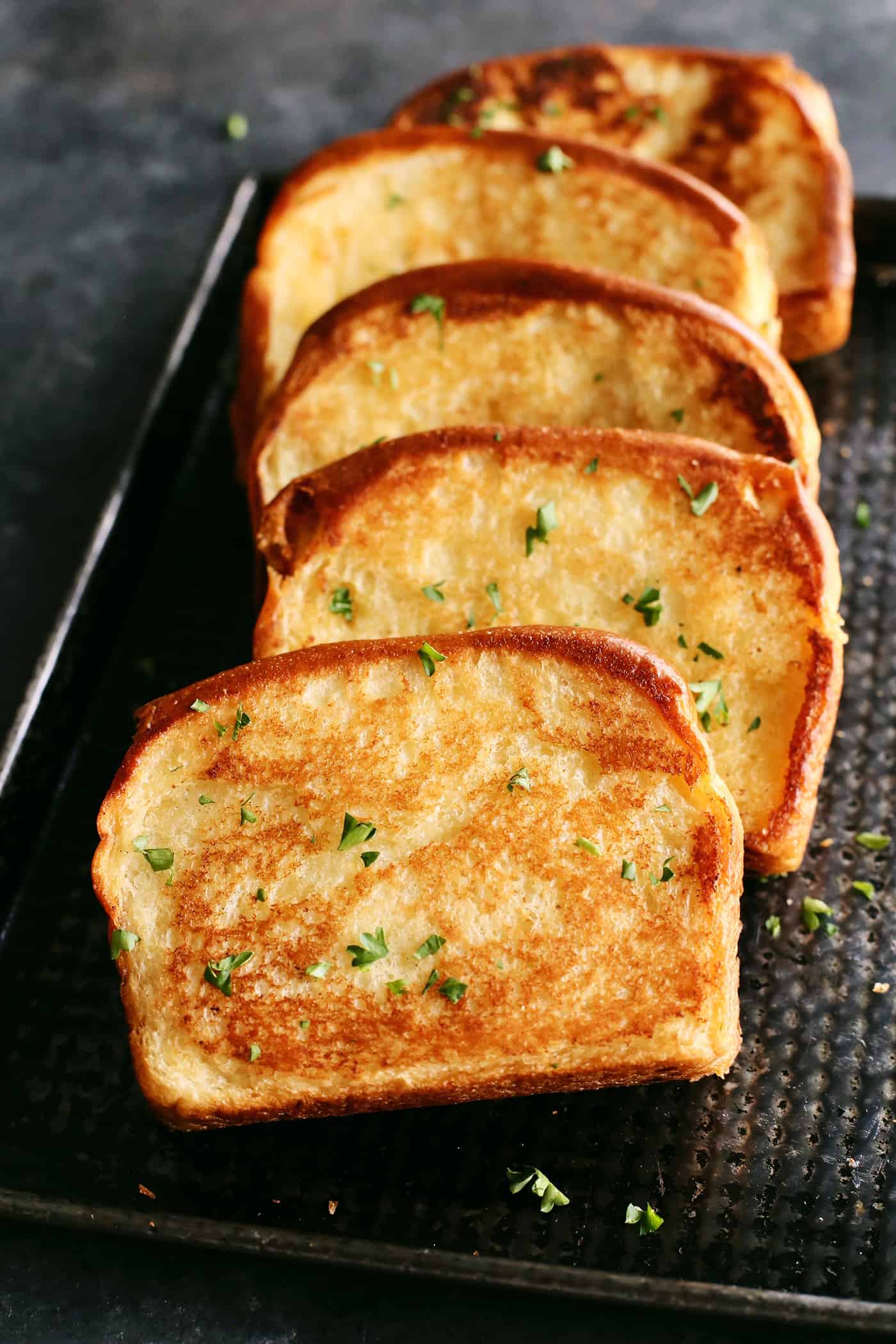 This Homemade Texas Toast Garlic Bread is made entirely on the stovetop with just 3 ingredients. It's the perfect addition to any meal. Slices of texas toast
