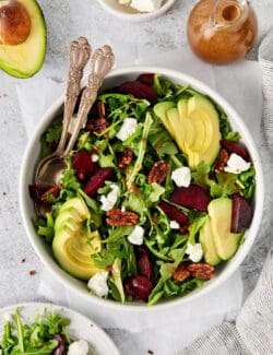 Overhead view of a bowl of arugula goat cheese salad