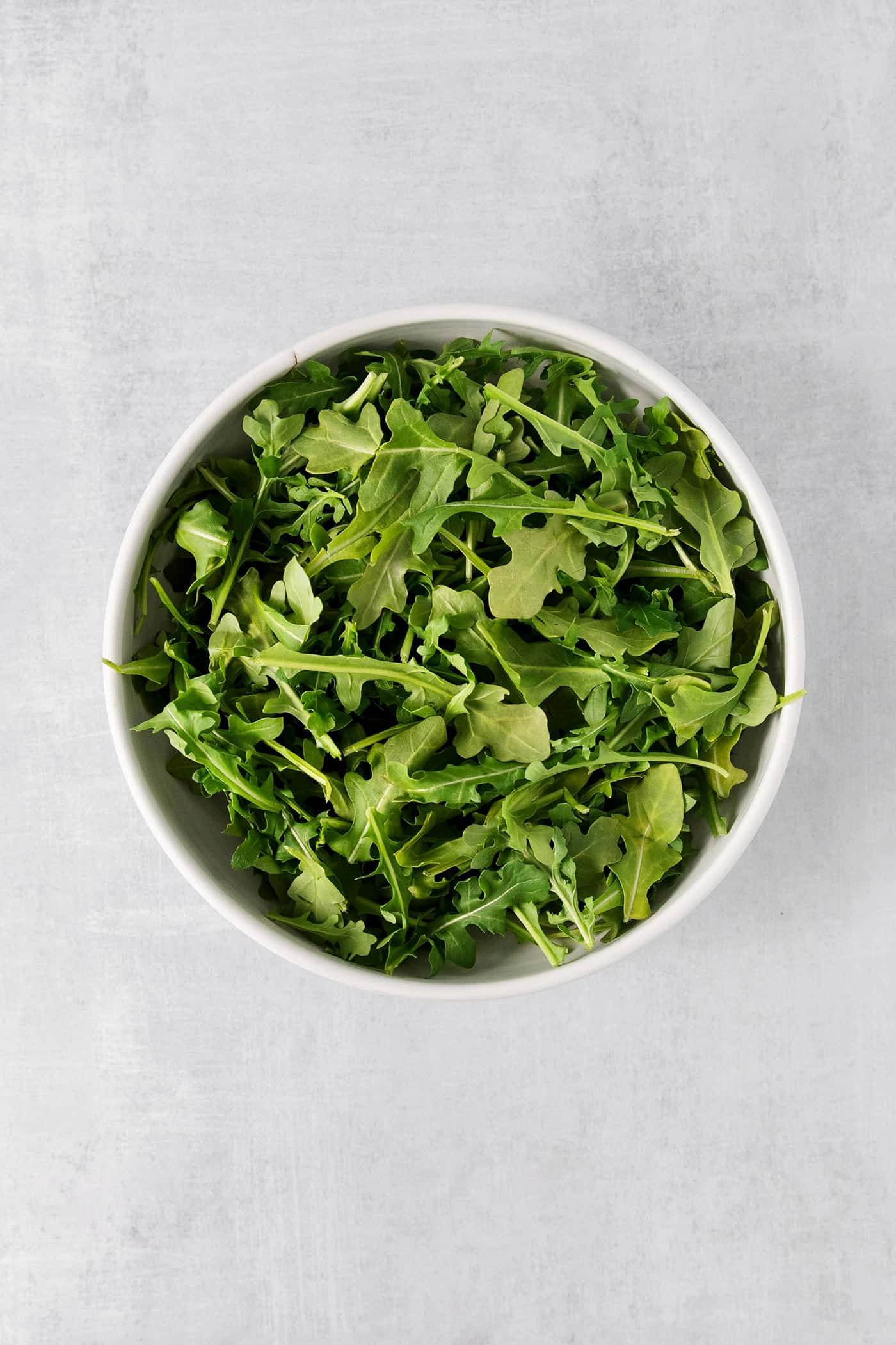 Topped with goat cheese, avocado, and candied pecans, this Arugula Beet Salad offers the perfect combination of flavors. A bowl of arugula