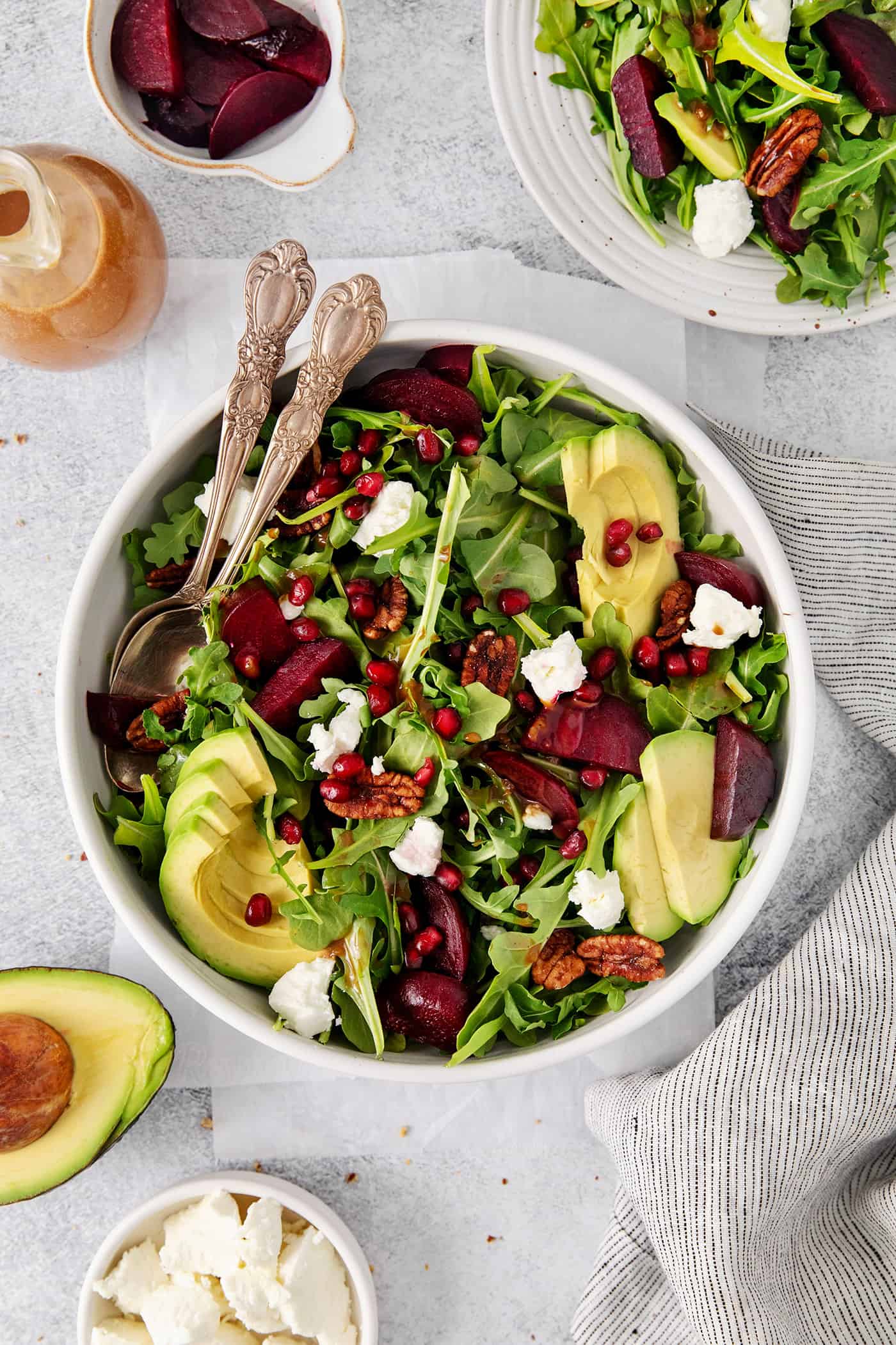 Topped with goat cheese, avocado, and candied pecans, this Arugula Beet Salad offers the perfect combination of flavors. Arugula beet salad topped with pomegranate