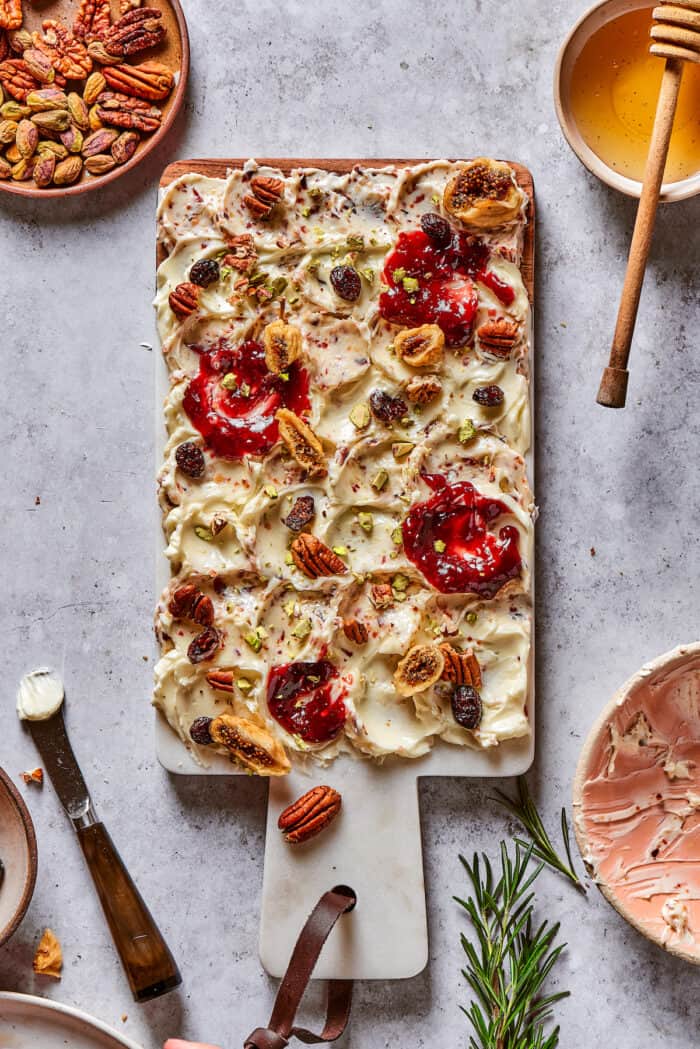 This Butter Board with Bacon Butter features toppings like dried fruits, nuts, and honey for an easy, savory butter charcuterie board. Jam and dried fruits on a butter board