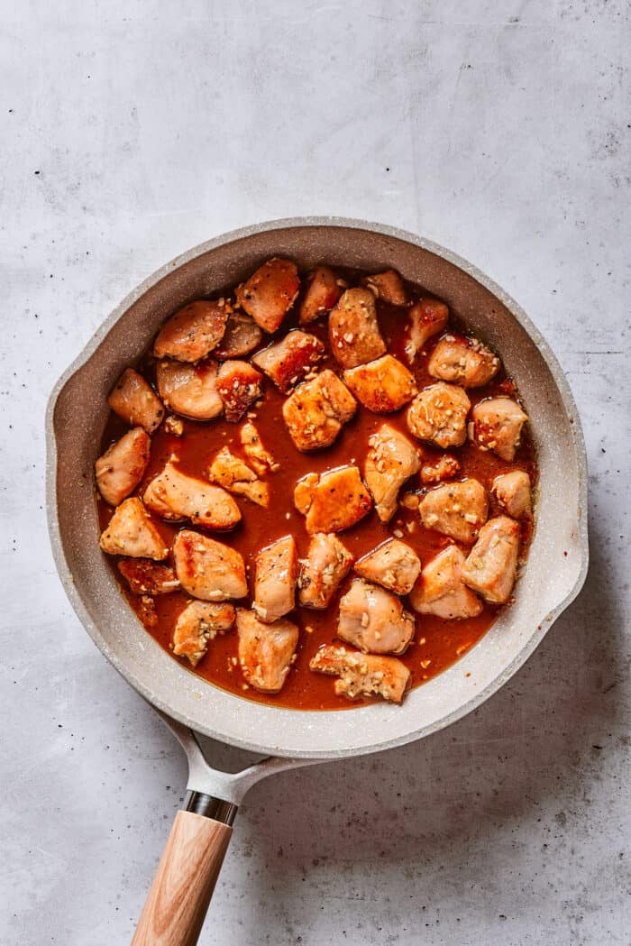 Quick, easy, and so flavorful, this Cashew Chicken stir fry features juicy pieces of chicken breast and cashews tossed in a garlic sauce. Chunks of chicken breast in a sauce in a frying pan
