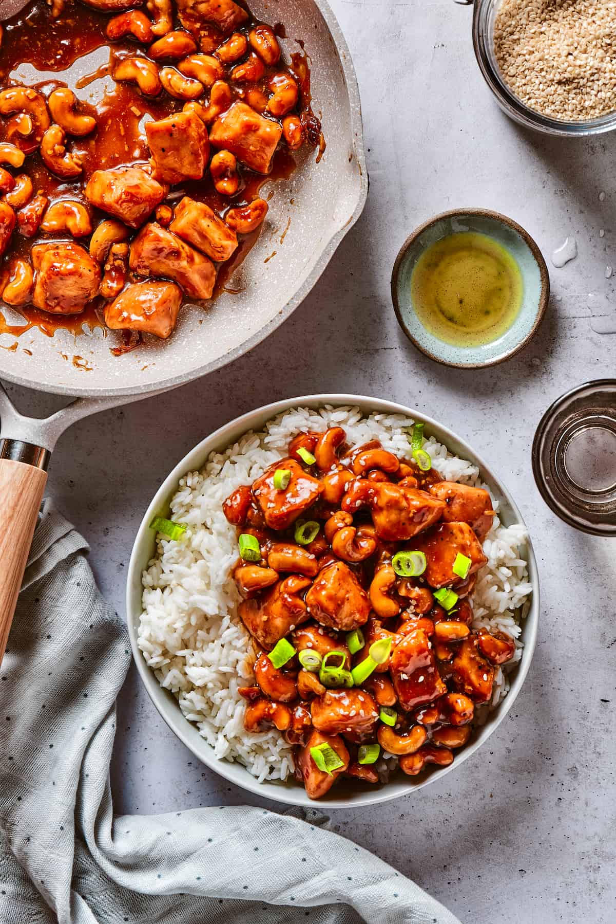 Quick, easy, and so flavorful, this Cashew Chicken stir fry features juicy pieces of chicken breast and cashews tossed in a garlic sauce. Overhead view of cashew chicken on a plate of rice