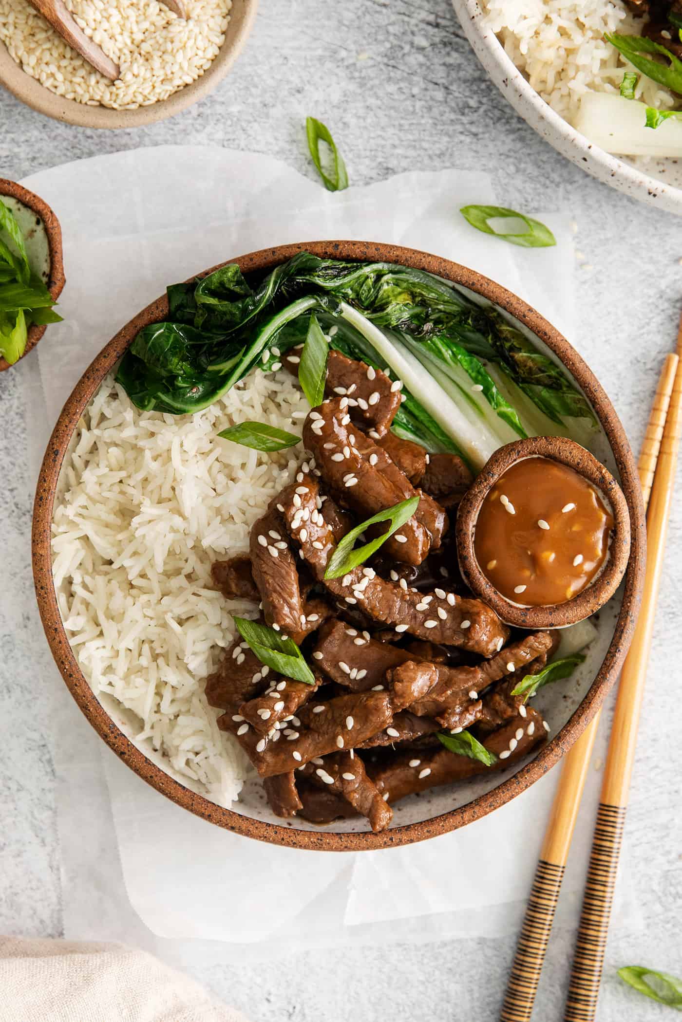 These Beef Bulgogi Rice Bowls are an easy copycat of your favorite Korean BBQ! Flavorful beef bulgogi is served with crisp bok choy and rice. Overhead view of beef bulgogi rice bowl