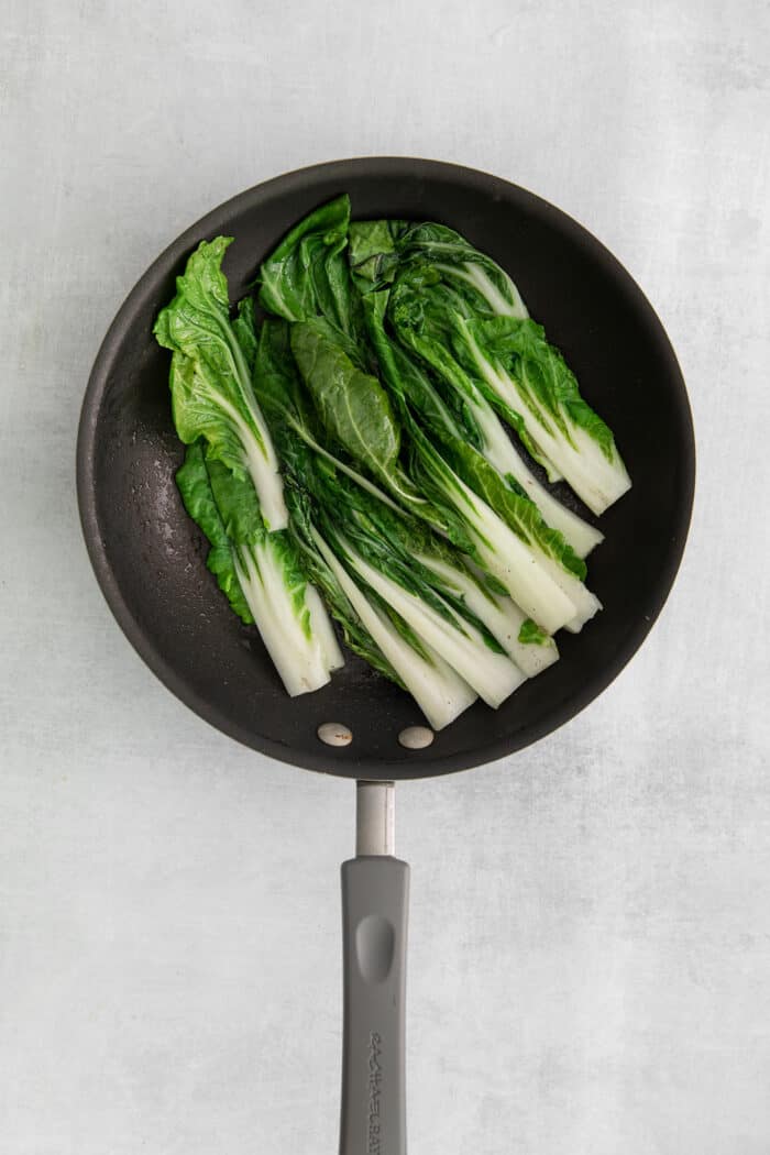 These Beef Bulgogi Rice Bowls are an easy copycat of your favorite Korean BBQ! Flavorful beef bulgogi is served with crisp bok choy and rice. Bok choy in a pan