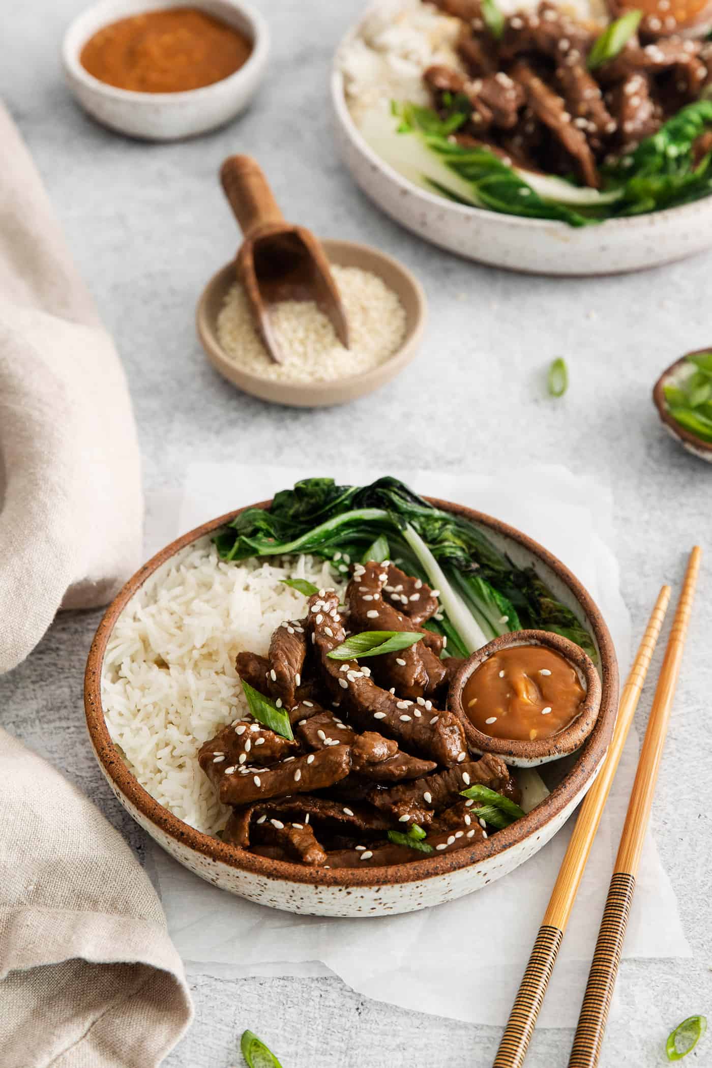 These Beef Bulgogi Rice Bowls are an easy copycat of your favorite Korean BBQ! Flavorful beef bulgogi is served with crisp bok choy and rice. Angled view of a beef bulgogi rice bowl