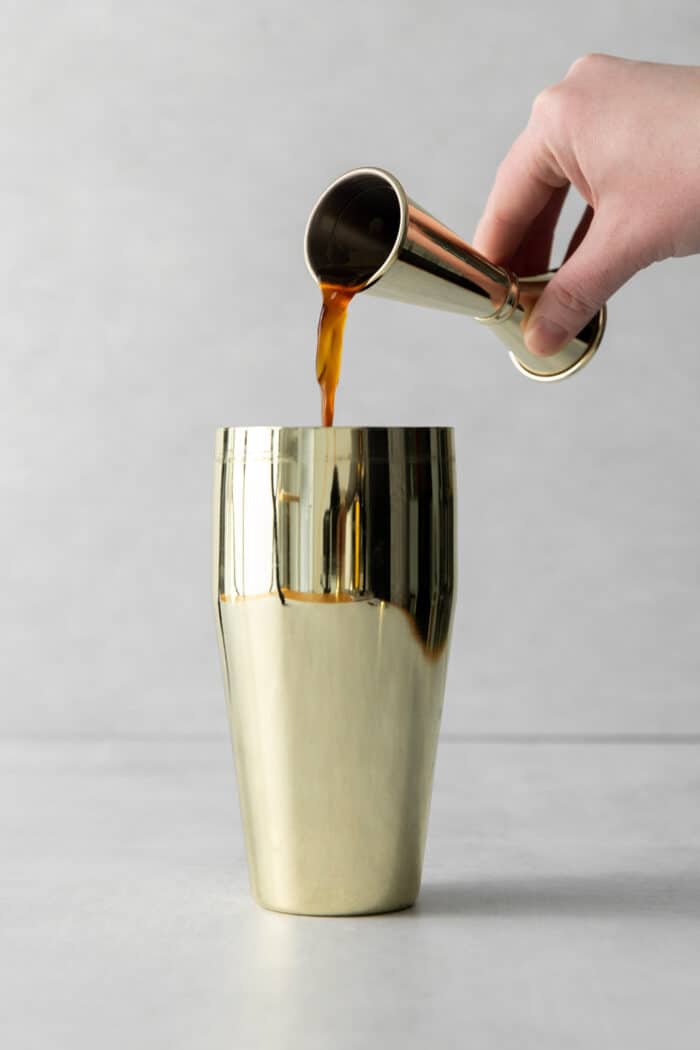 Made with espresso, vodka, and two liqueurs, this Espresso Martini is a strong coffee cocktail that's sure to provide an afternoon boost. Coffee being poured into a shaker