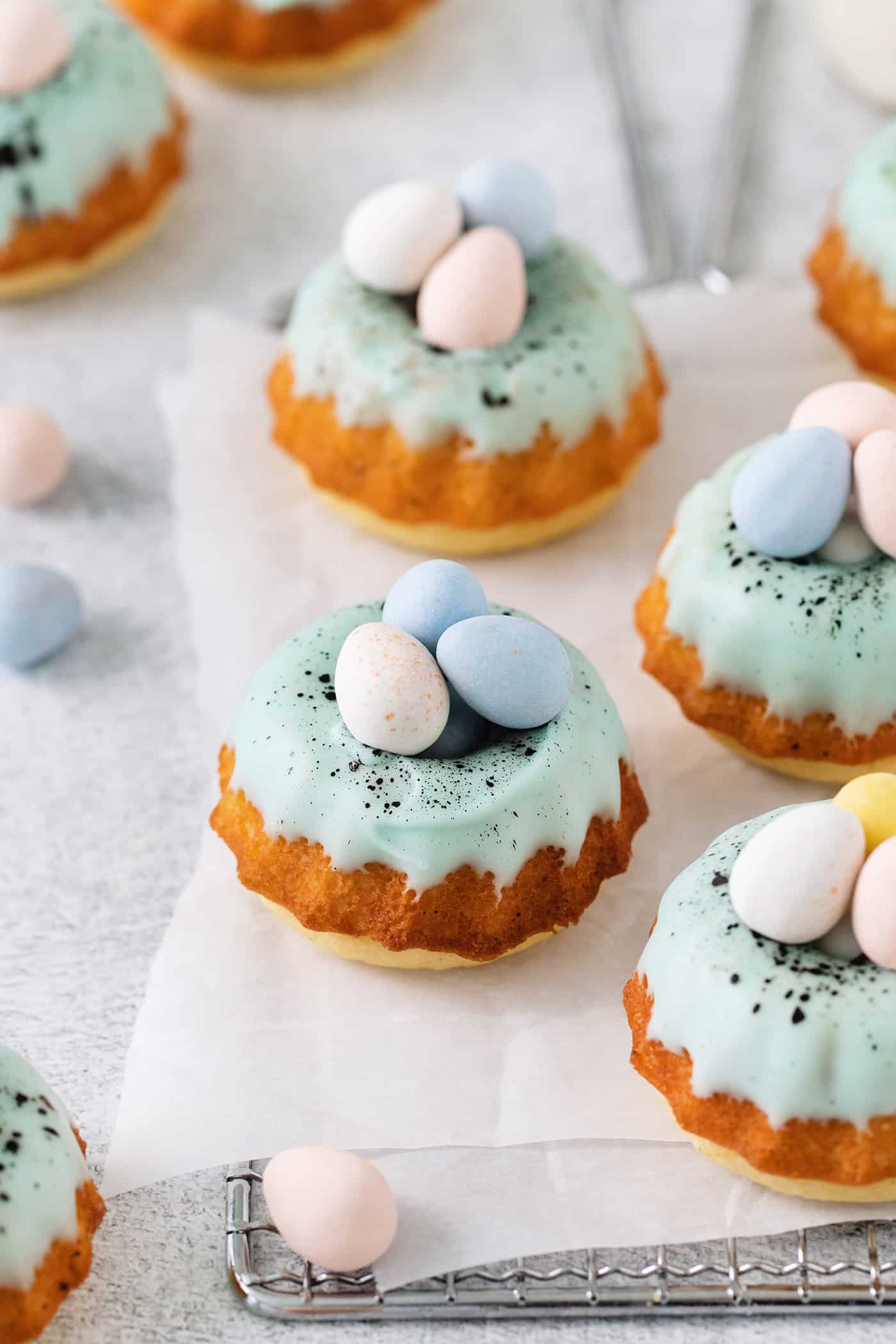 These Robin’s Egg Mini Bundt Cakes are the perfect sweet springtime treat. A moist, vanilla cake topped with a sweet glaze! Overhead view of robin's egg mini bundt cakes