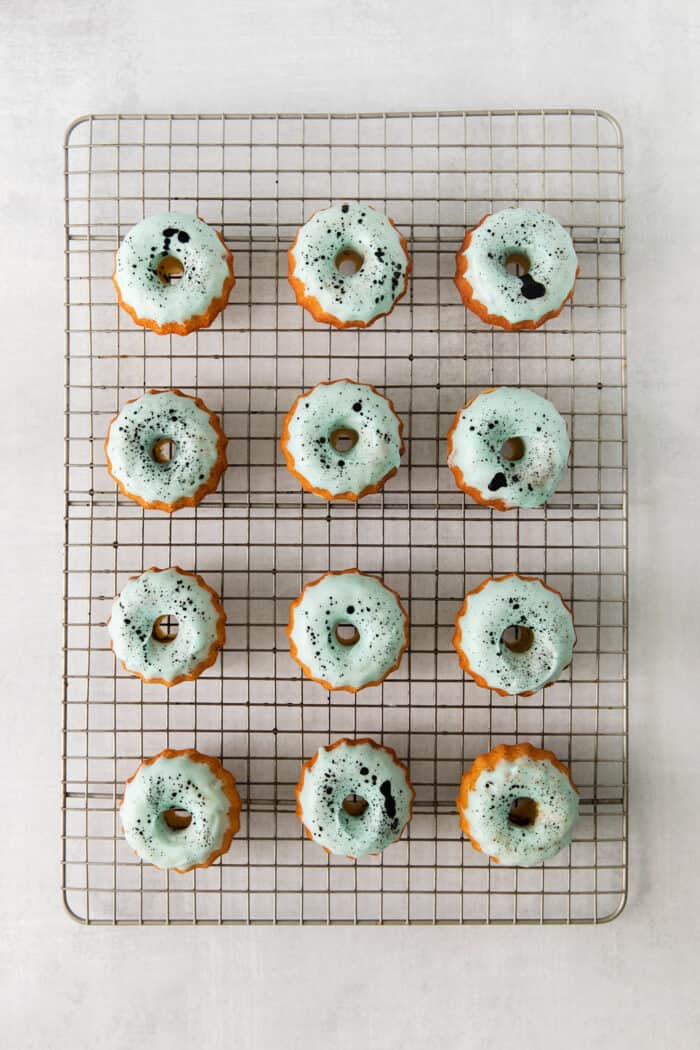 These Robin’s Egg Mini Bundt Cakes are the perfect sweet springtime treat. A moist, vanilla cake topped with a sweet glaze! Overhead view of mini bundt cakes topped with icing