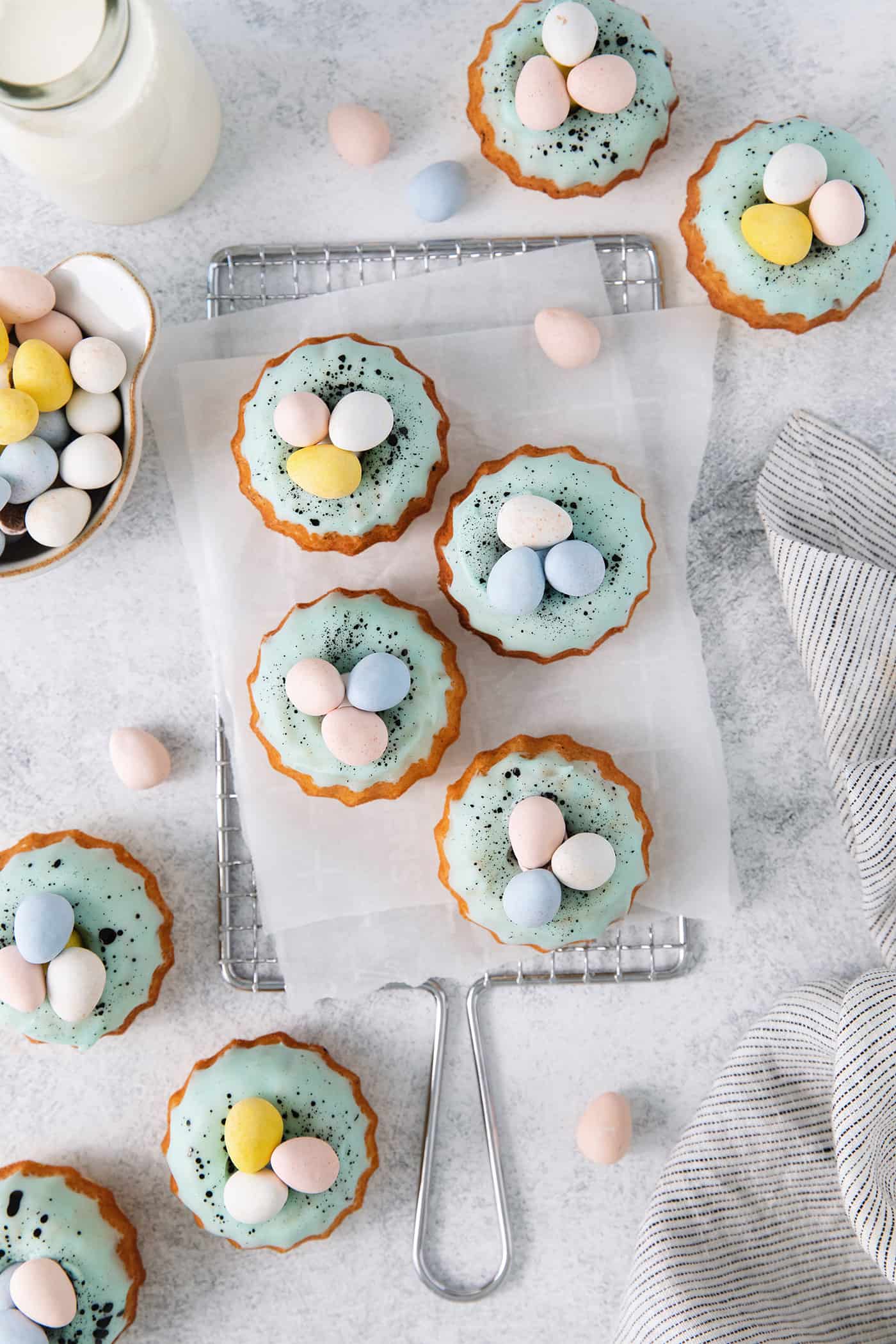These Robin’s Egg Mini Bundt Cakes are the perfect sweet springtime treat. A moist, vanilla cake topped with a sweet glaze! Overhead view of robin's egg bundt cakes