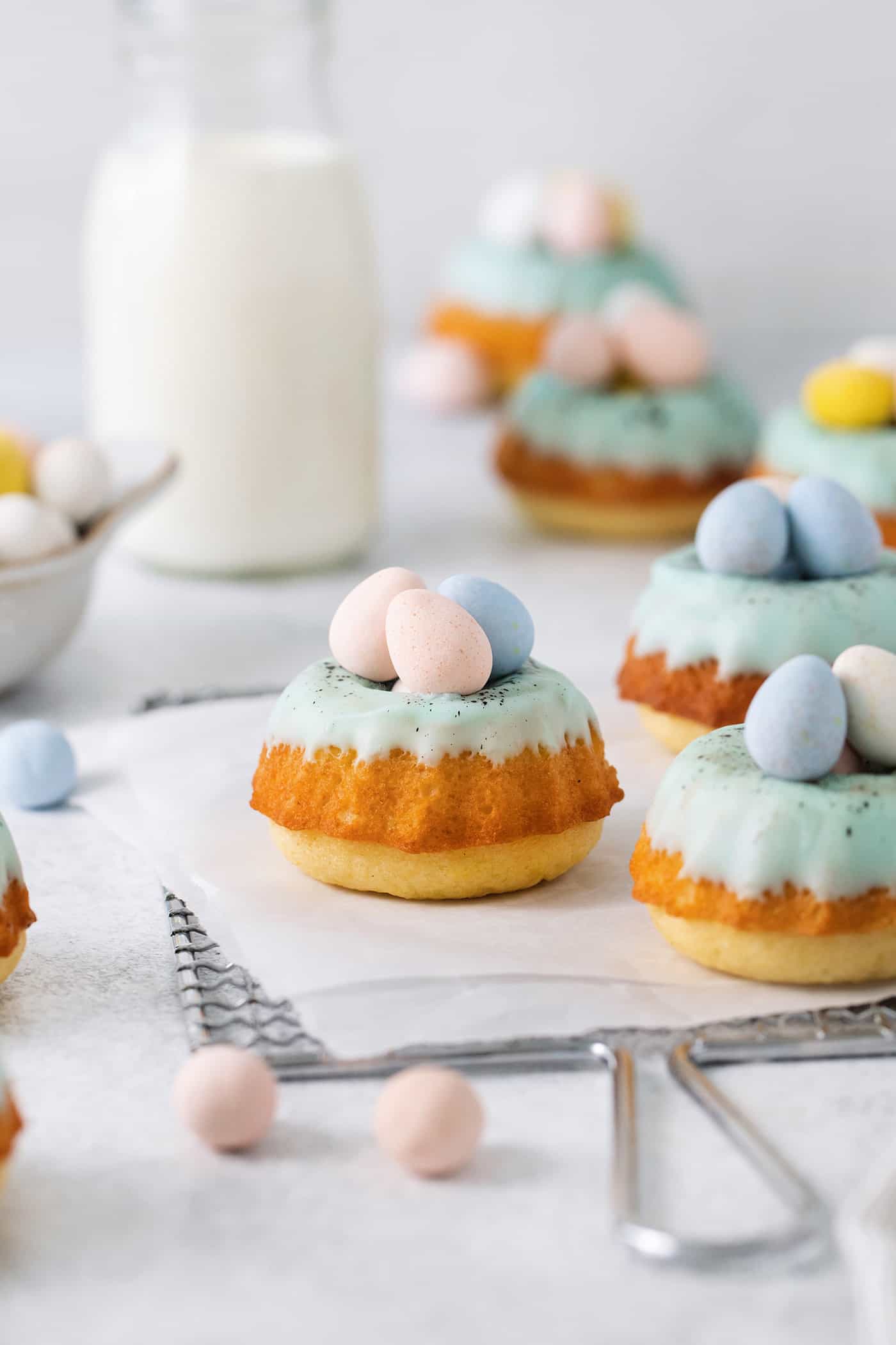 These Robin’s Egg Mini Bundt Cakes are the perfect sweet springtime treat. A moist, vanilla cake topped with a sweet glaze! Side side of Easter mini bundt cakes