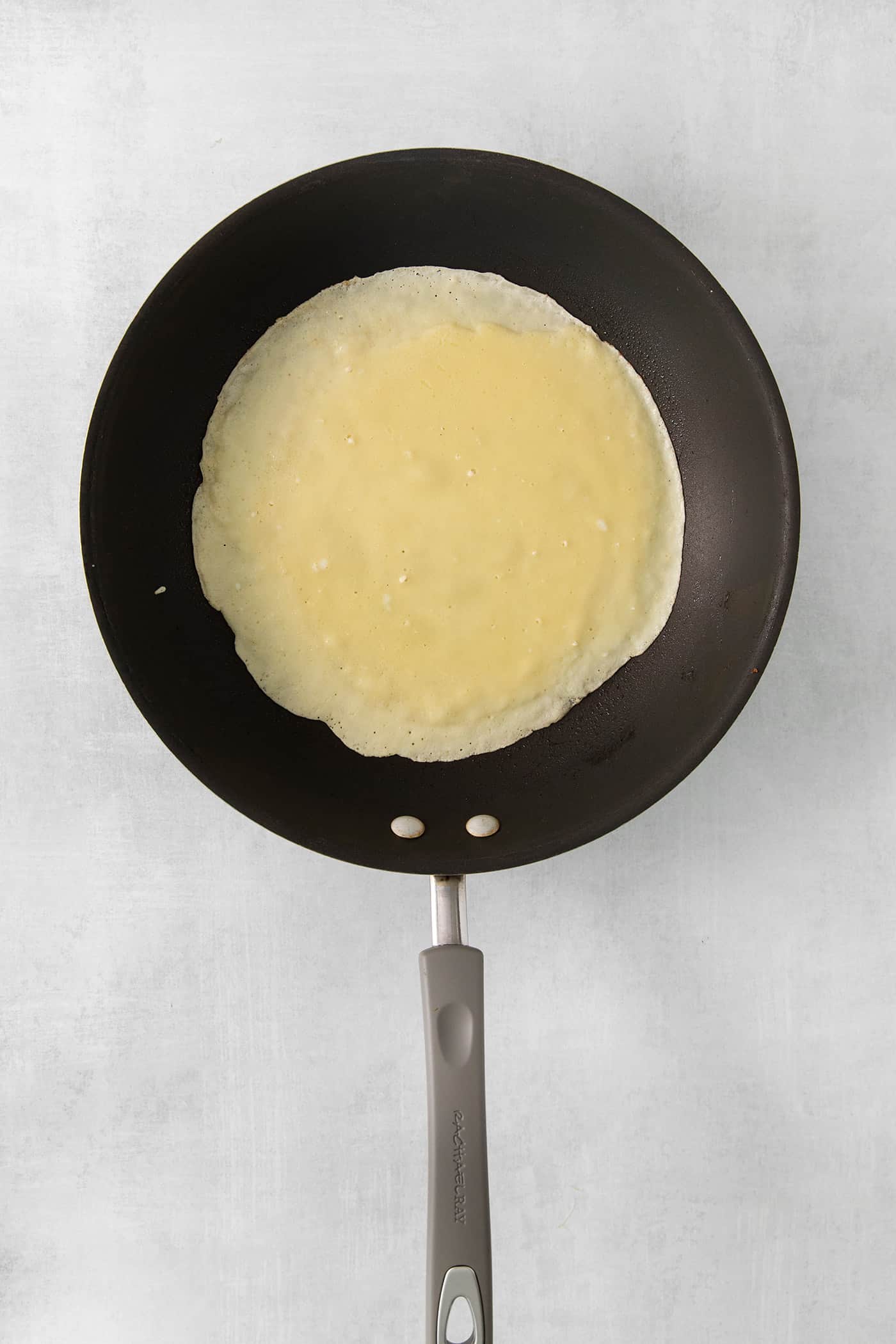 Make French crepes this Mother's Day and treat mom to an elegant, melt-in-your-mouth brunch dish with continental flair. Cooking a crepe in a pan.