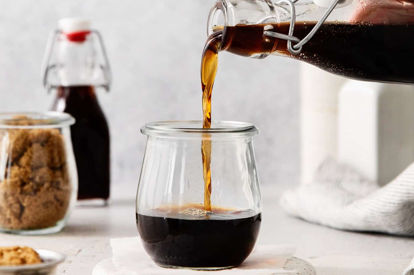 Brown sugar simple syrup being added to a glass