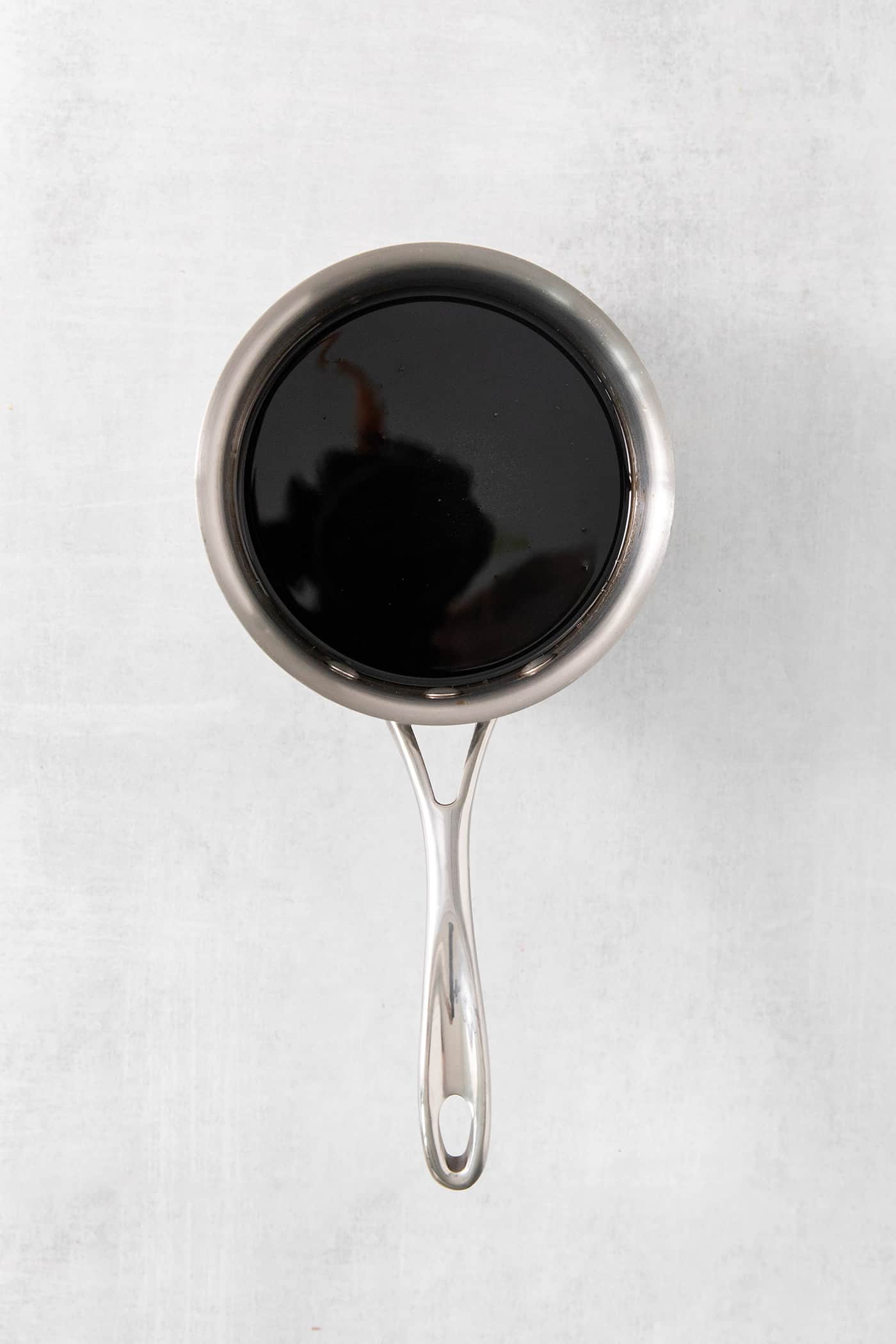 This Brown Sugar Syrup is quick and easy to prepare, with just 3 ingredients - water, brown sugar, and salt. Brown sugar syrup in a saucepan