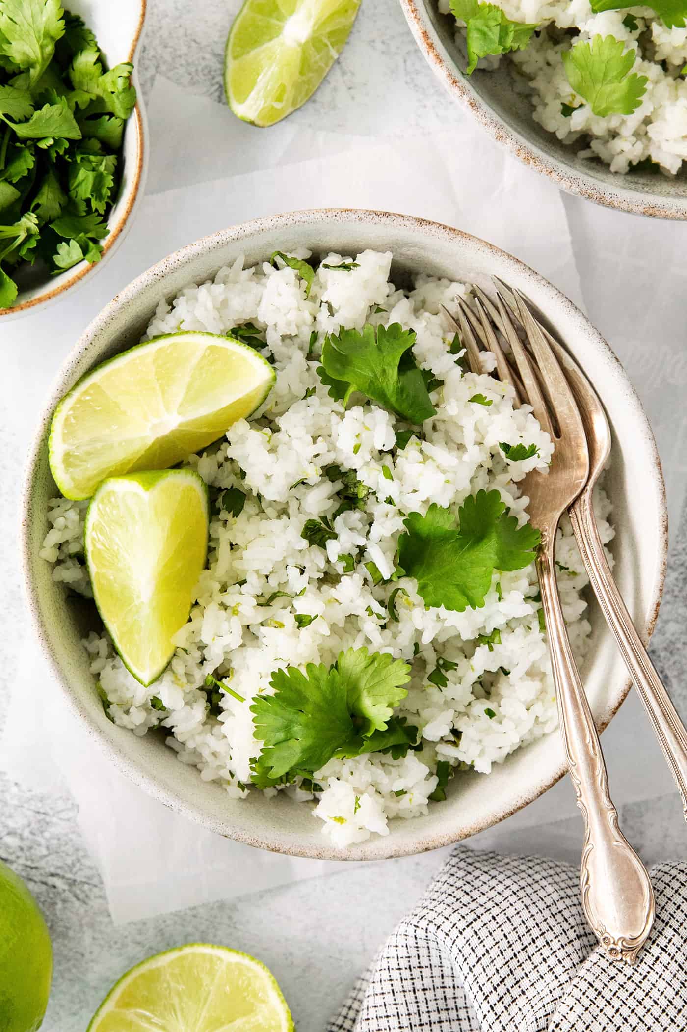 Cilantro Lime Rice is the perfect base or side for so many recipes. The rice is perfectly cooked and seasoned with hints of lime & cilantro. Overhead view of a bowl of cilantro lime rice