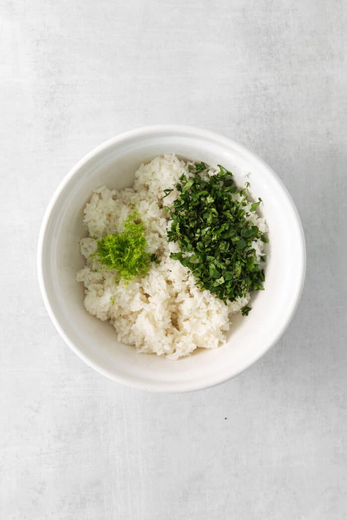 Cilantro Lime Rice is the perfect base or side for so many recipes. The rice is perfectly cooked and seasoned with hints of lime & cilantro. Cilantro lime rice ingredients in a bowl