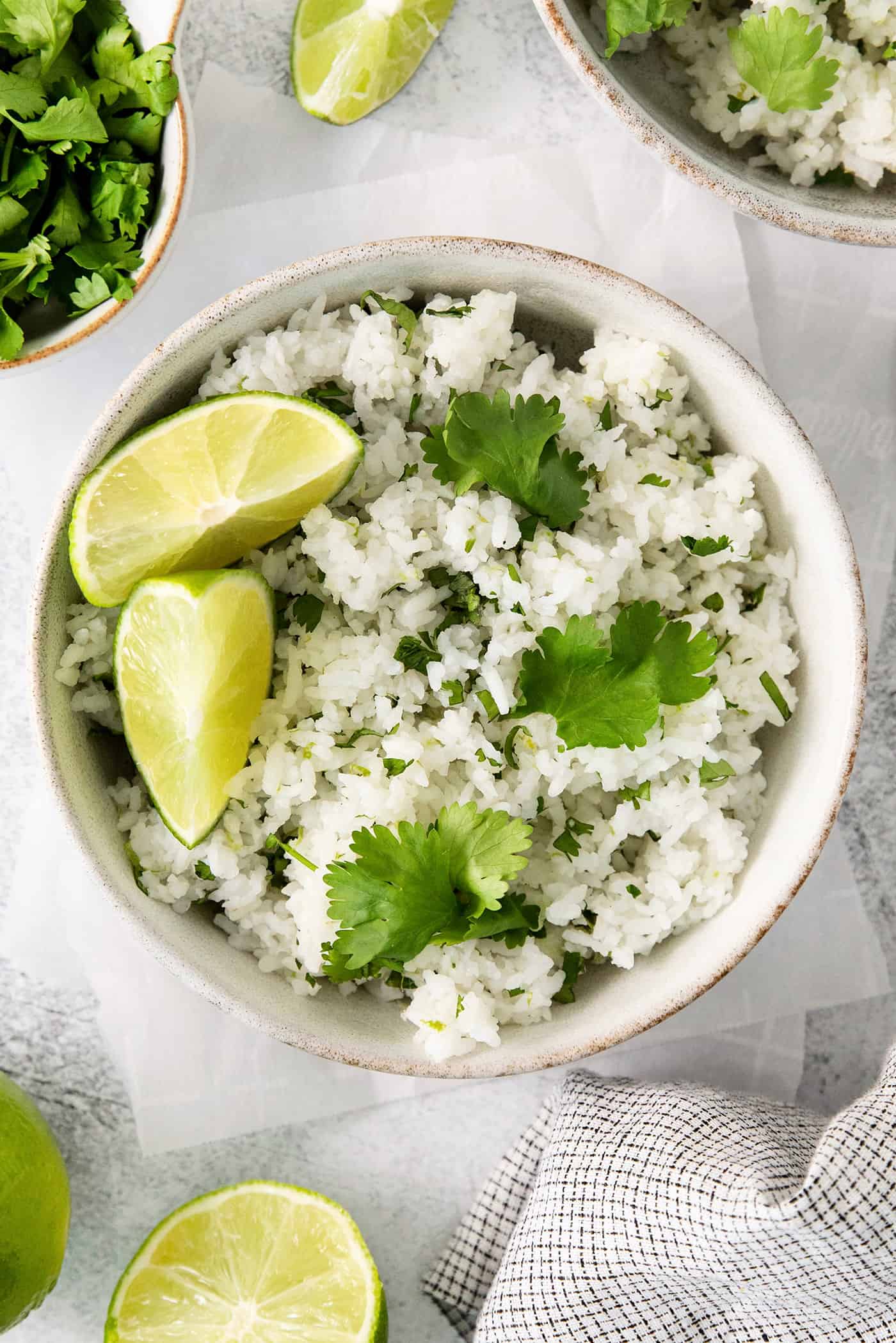 Cilantro Lime Rice is the perfect base or side for so many recipes. The rice is perfectly cooked and seasoned with hints of lime & cilantro. Overhead view of a bowl of cilantro rice